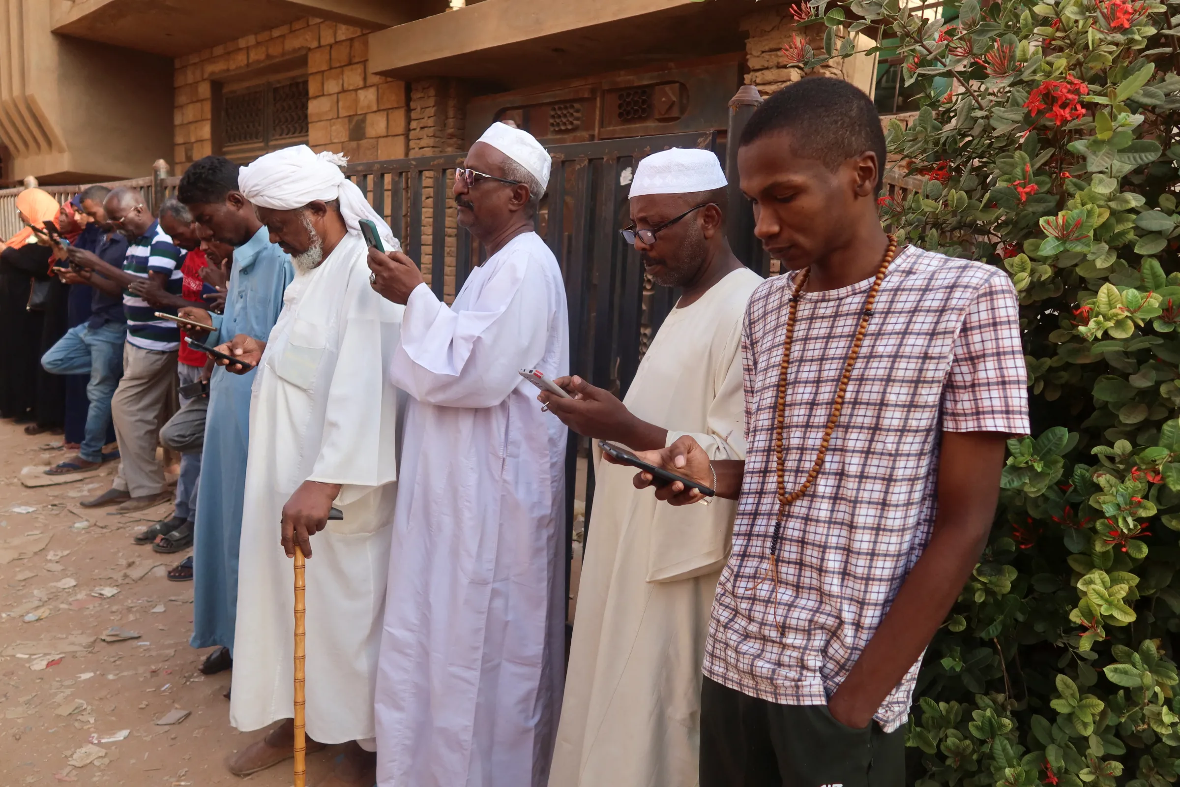 Residents and displaced people try to access the internet via Starlink in the city of Omdurman, Sudan, March 9, 2024. REUTERS/El Tayeb Siddig