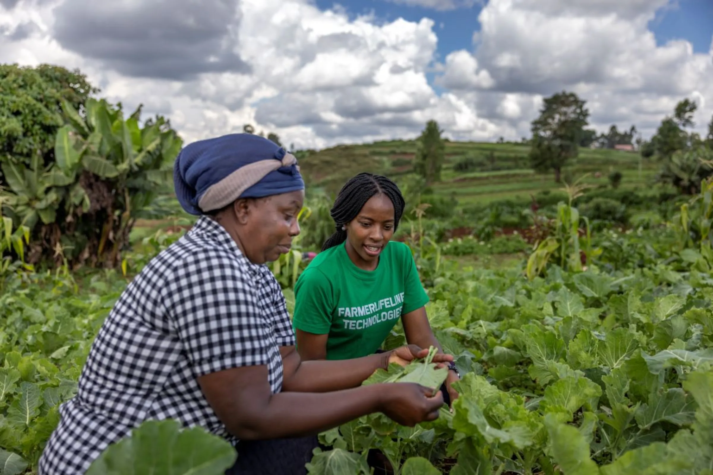 FarmerLifeline CEO and founder Esther Wanjiru checks crops with Marion Nyawira Mburu at her farm in Nairobi, Kenya, on November 6, 2023. Royal Academy of Engineering 2024/Handout via Thomson Reuters Foundation
