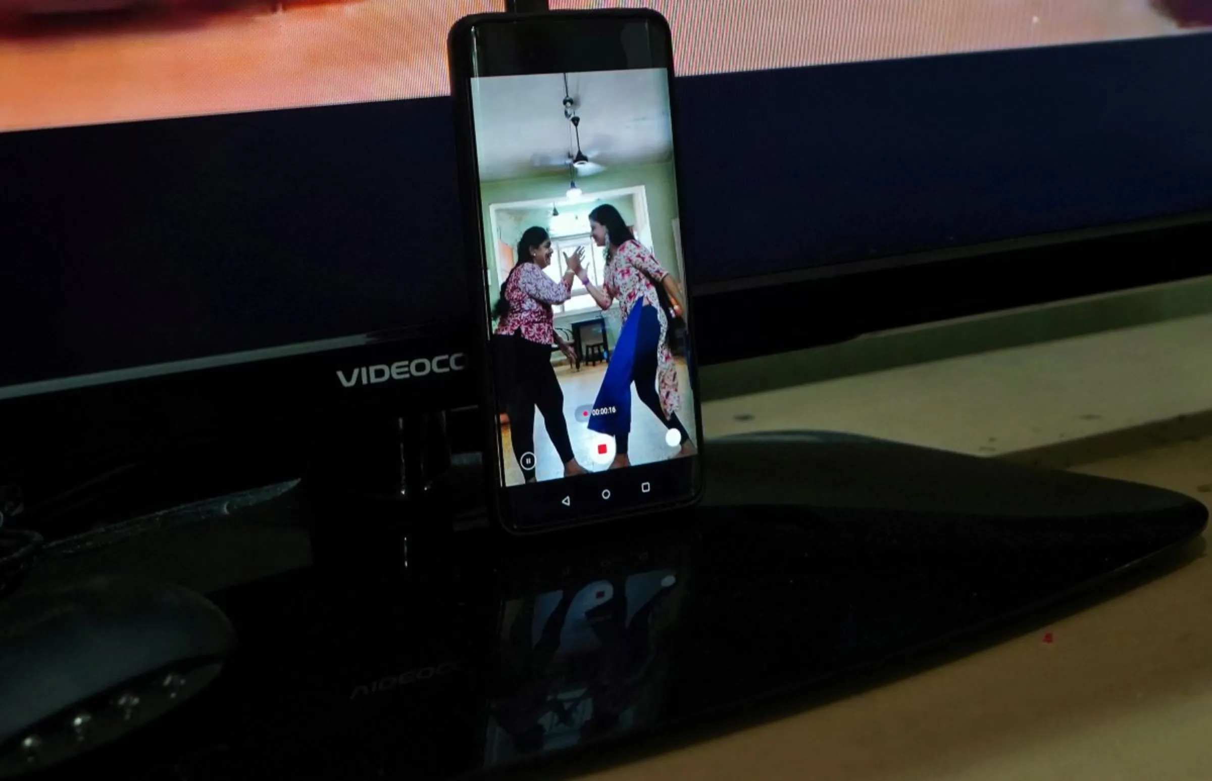 A woman who used to post over a dozen videos on video-sharing app TikTok, and her daughter are seen in a mobile phone's screen as they make a video that they said will upload on an Indian app, after India banned dozens of Chinese apps including TikTok following a border clash between the two nations, inside their house in Mumbai, India, July 1, 2020. REUTERS/Hemanshi Kamani