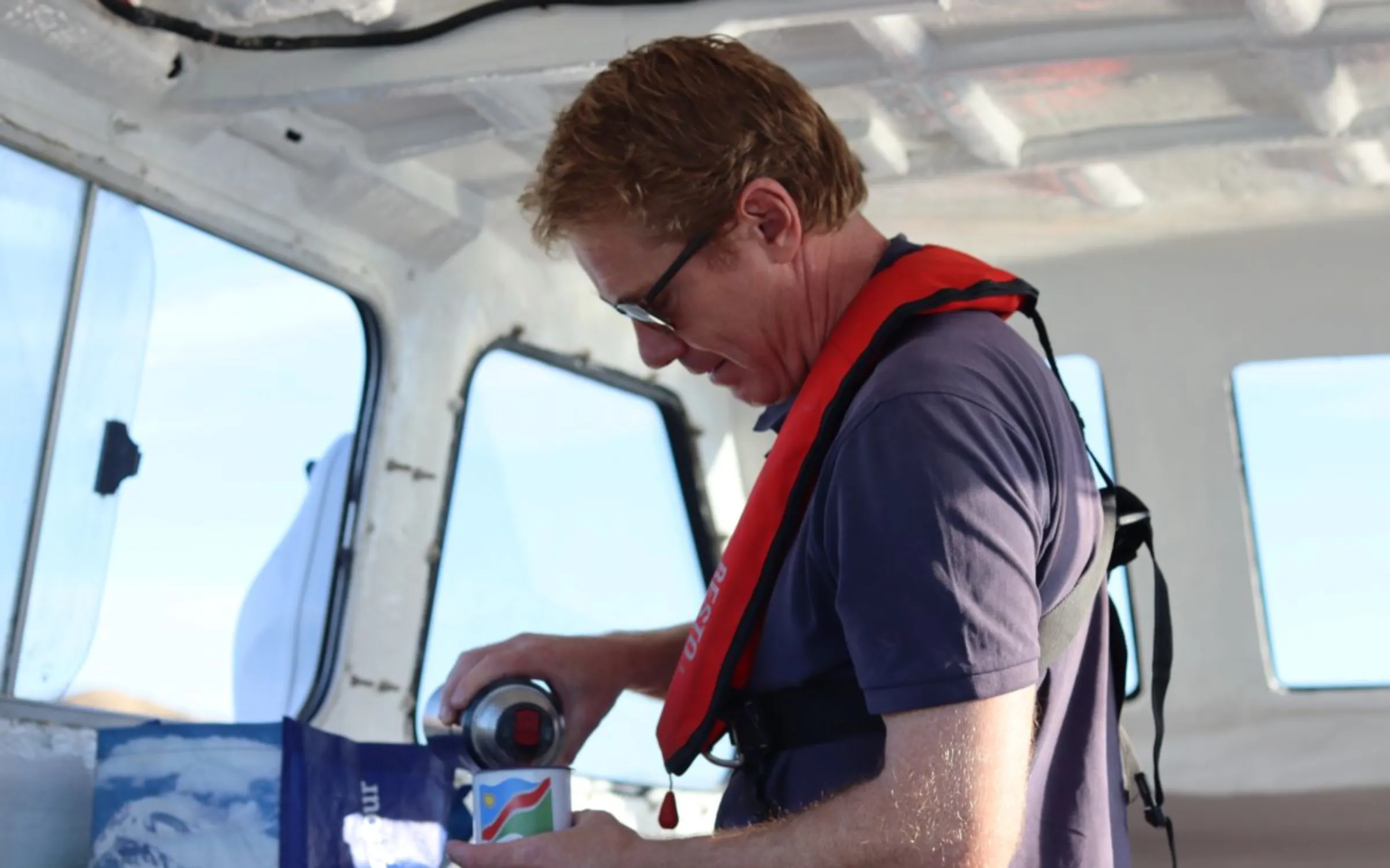 Daniel Hooft, CEO of Kelp Blue, a seaweed farming startup on deck of the Whale Rider in Lüderitz in ǁKaras region, Namibia, April 23, 2023. Thomson Reuters Foundation/Lisa Ossenbrink