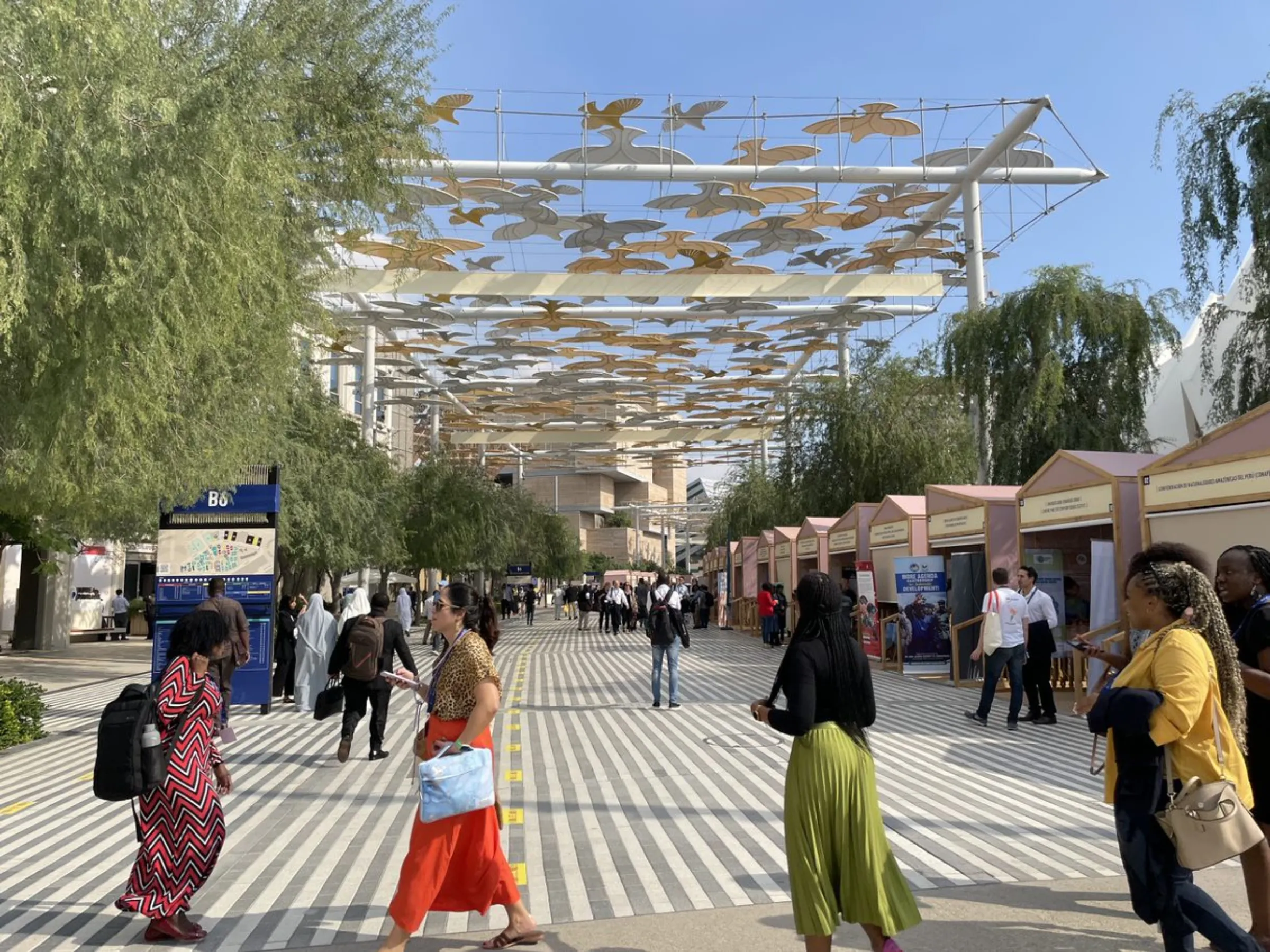 People walk outside the United Nations Climate Change Conference (COP28) in Dubai, United Arab Emirates, December 3, 2023. Thomson Reuters Foundation/Jack Graham