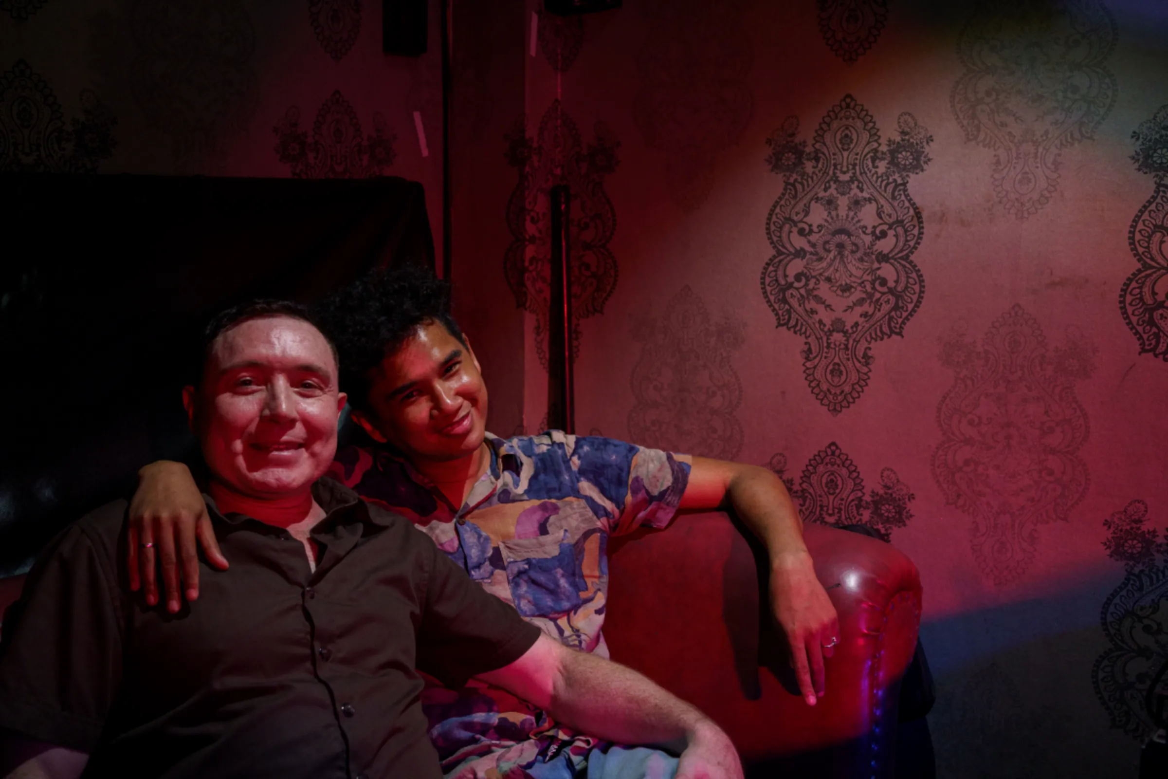 Sean L’Estrange poses with his husband Chakgai Jermkwan inside their bar, The Stranger Bar House of Drag Queens, in Bangkok, Thailand. Dec. 12, 2023. Thomas Cristofoletti/Ruom/Handout via Thomson Reuters Foundation
