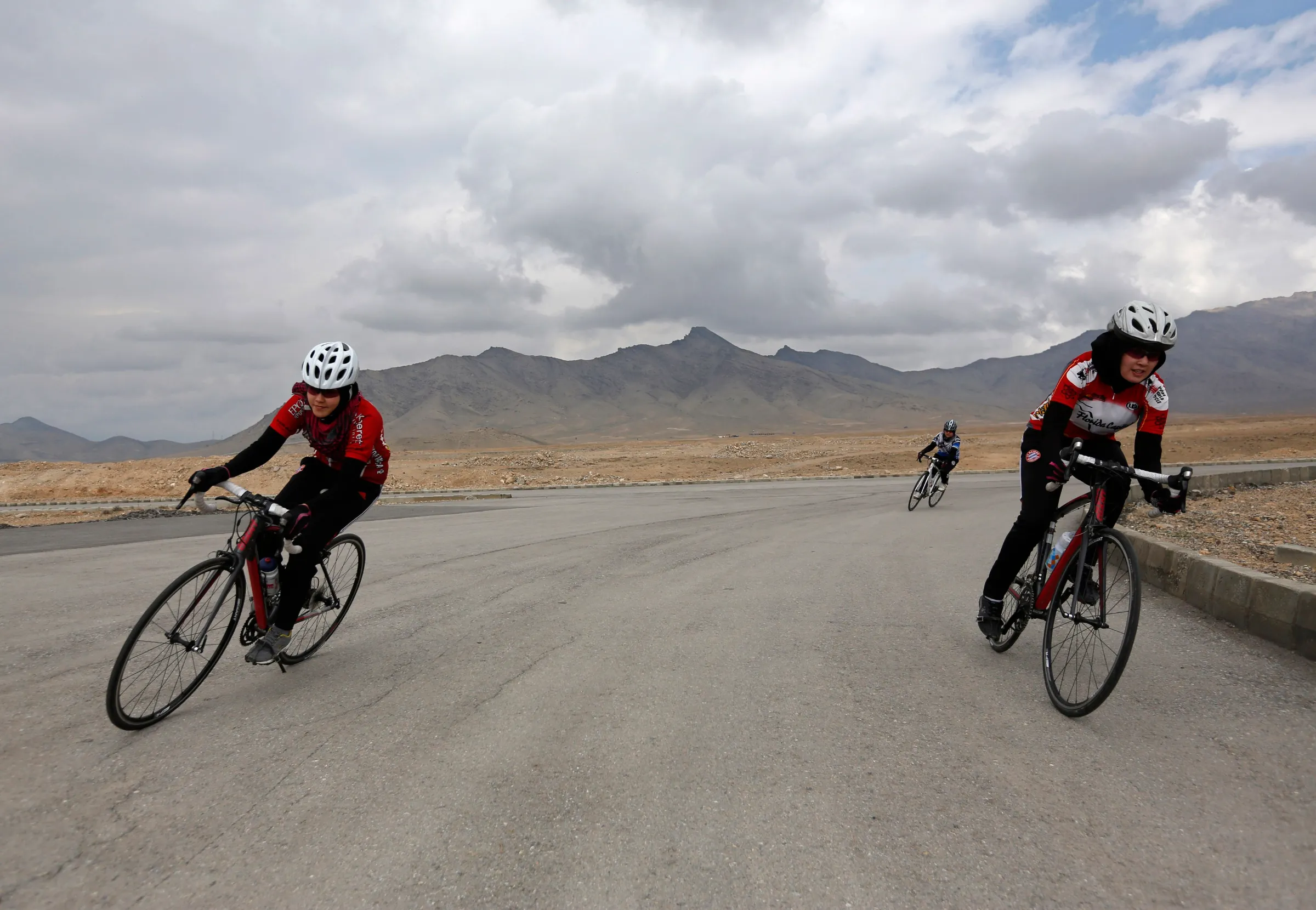 This archive photo shows Masomah Ali Zada (L), and sister Zahra Ali Zada (R), members of Afghanistan's Women's National Cycling Team, exercising on the outskirts of Kabul in February, 2015. REUTERS/Mohammad Ismail