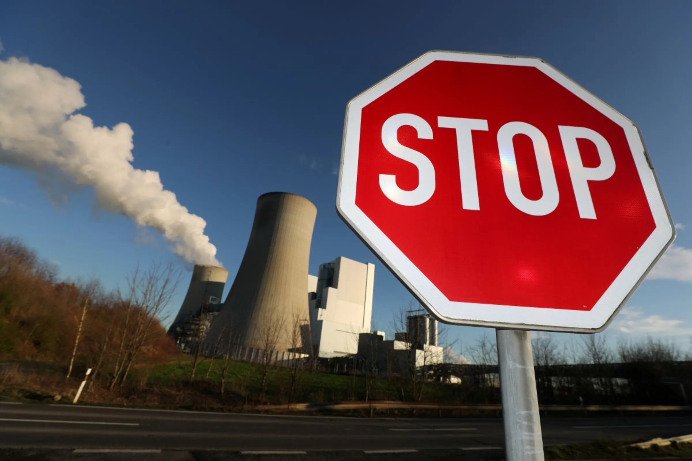 A Stop sign stands in front of the Neurath lignite power plant of German utility RWE, west of Cologne, Germany, January 16, 2020. REUTERS/Wolfgang Rattay