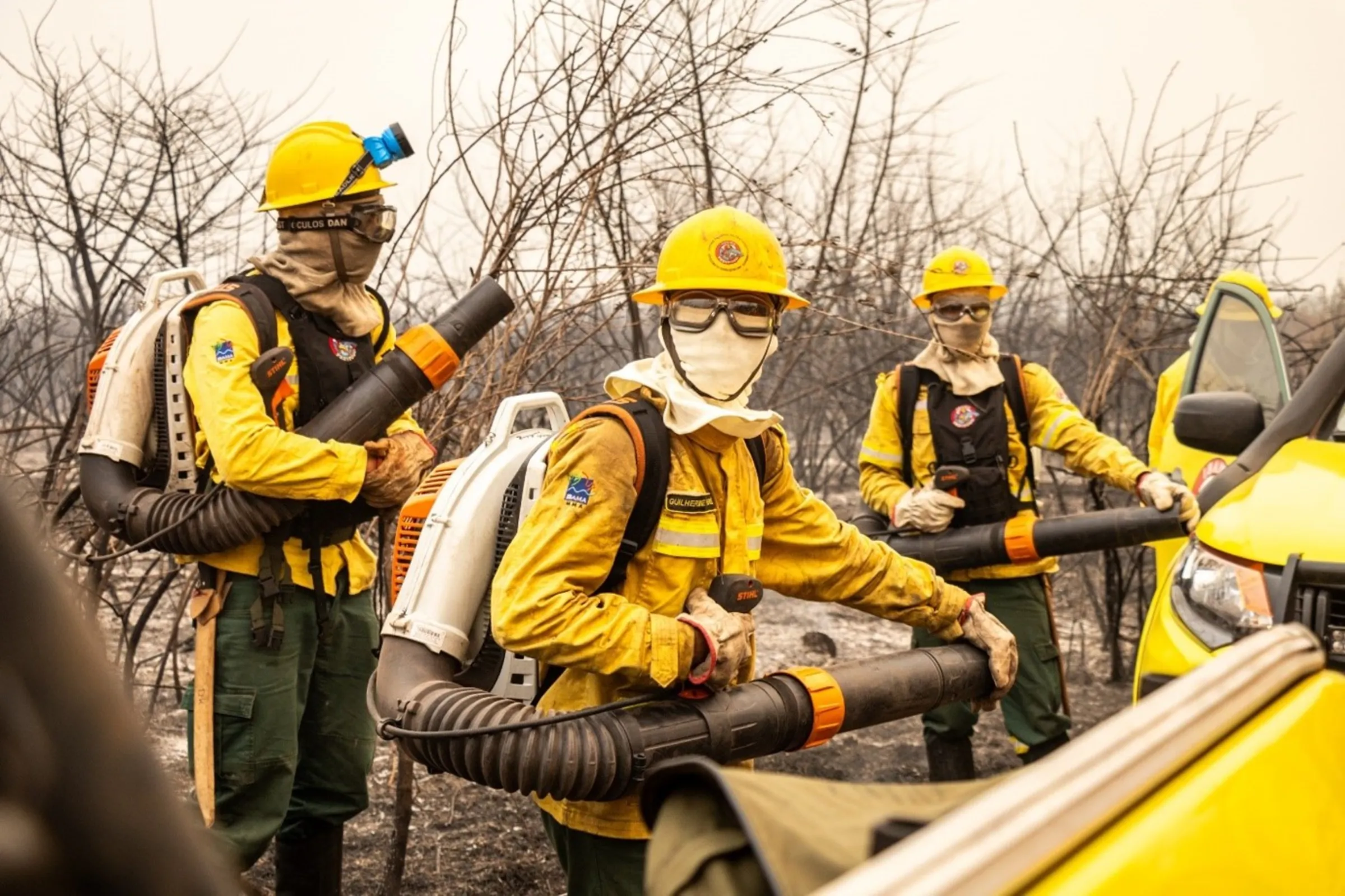 Kalunga firefighters from the Prevfogo brigade hold leaf blowers at the Pantanal wetland in Corumbá, Brazil, September, 11, 2024. Thomson Reuters Foundation/Henrique Kawaminami