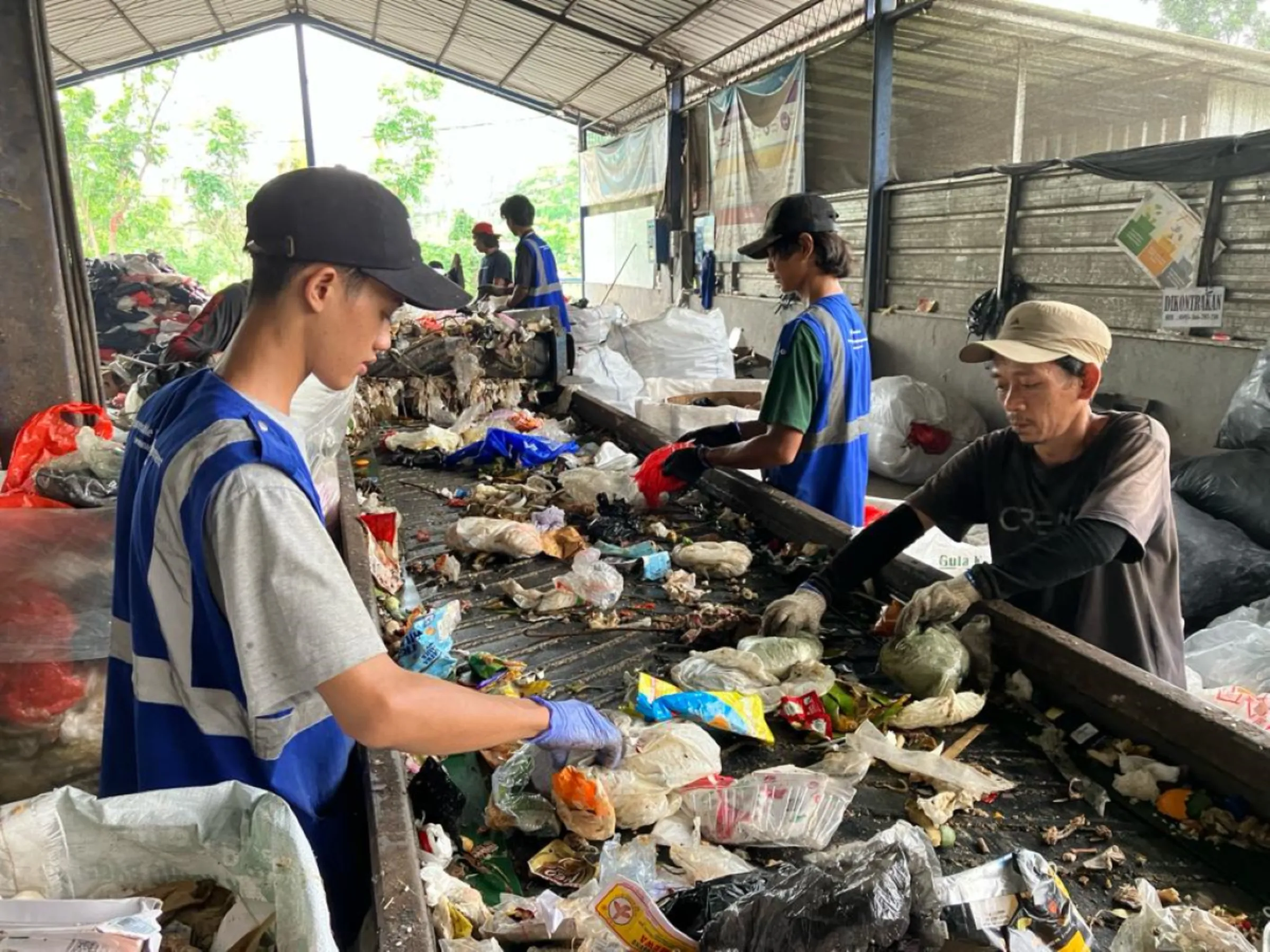 Workers sort trash at the Waste4Change recycling facility in Bekasi, Indonesia, November 24, 2023