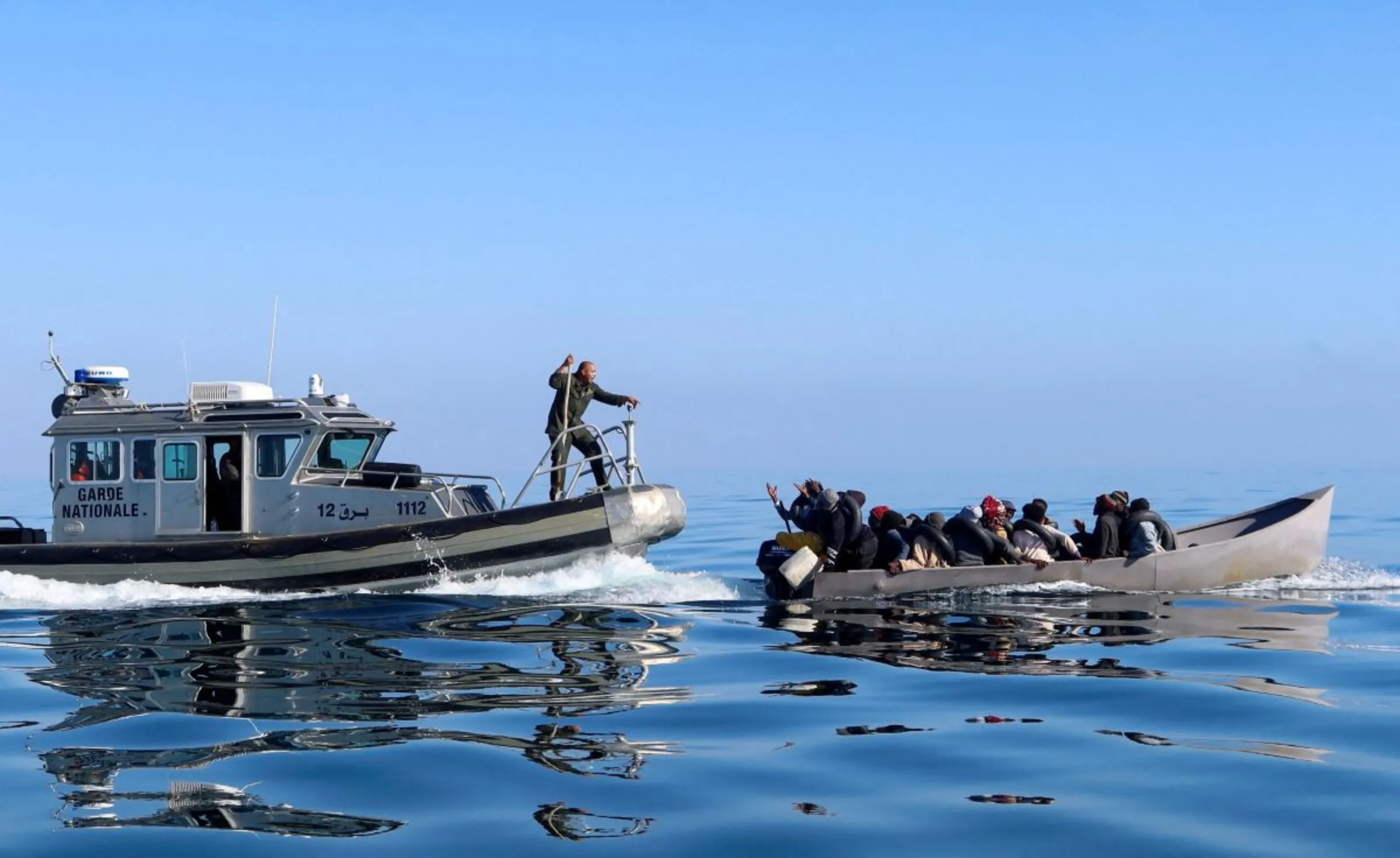Tunisian coast guards try to stop migrants at sea during their attempt to cross to Italy, off the coast off Sfax, Tunisia April 27, 2023. REUTERS/Jihed Abidellaoui