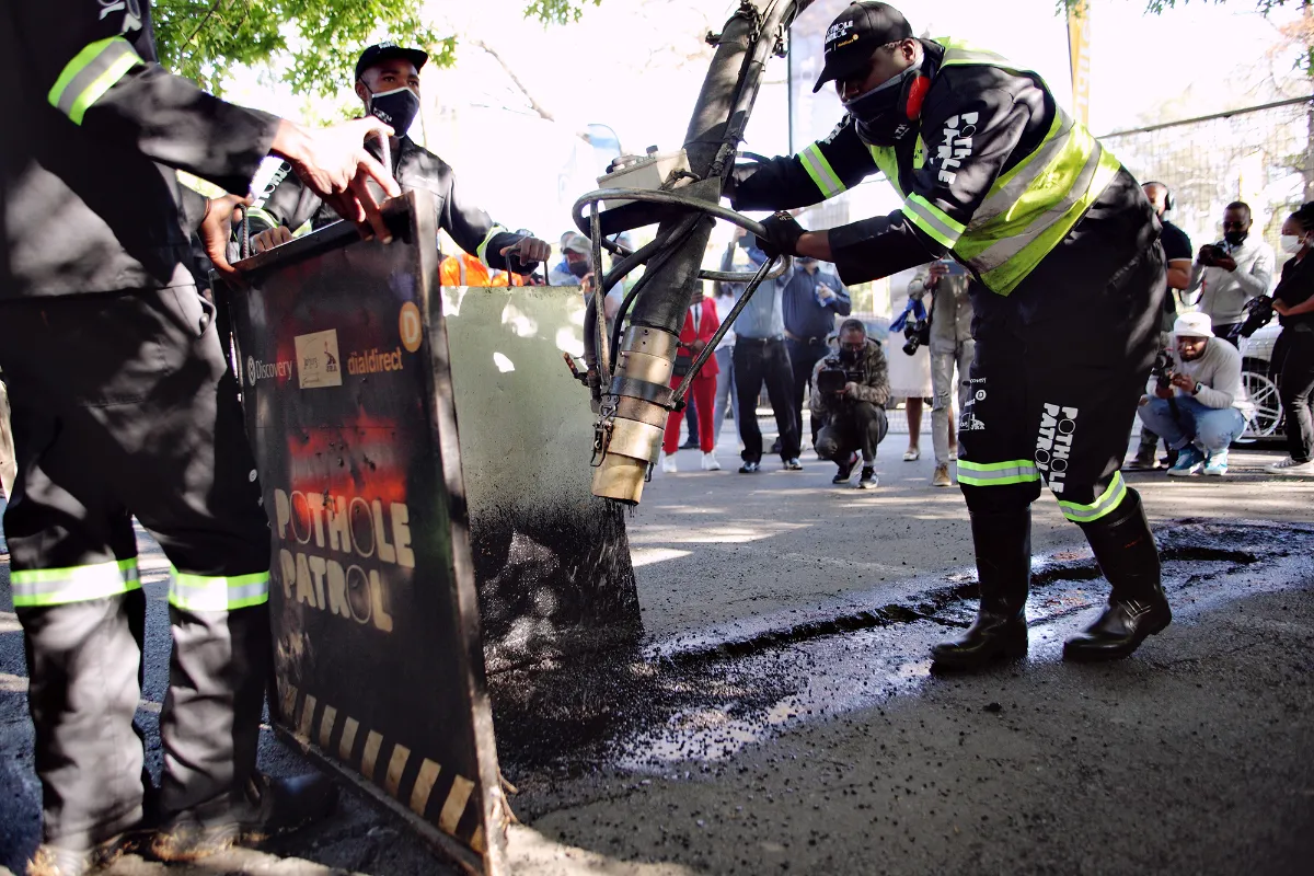 A pothole is filled by the Pothole Patrol at the launch of the app