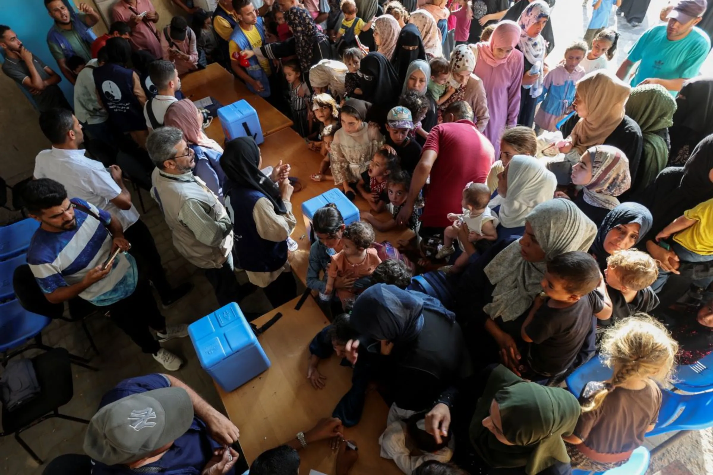 Palestinians gather for a polio vaccination campaign, at a United Nations healthcare center in Deir Al-Balah in the central Gaza Strip, September 1, 2024. REUTERS/Ramadan Abed