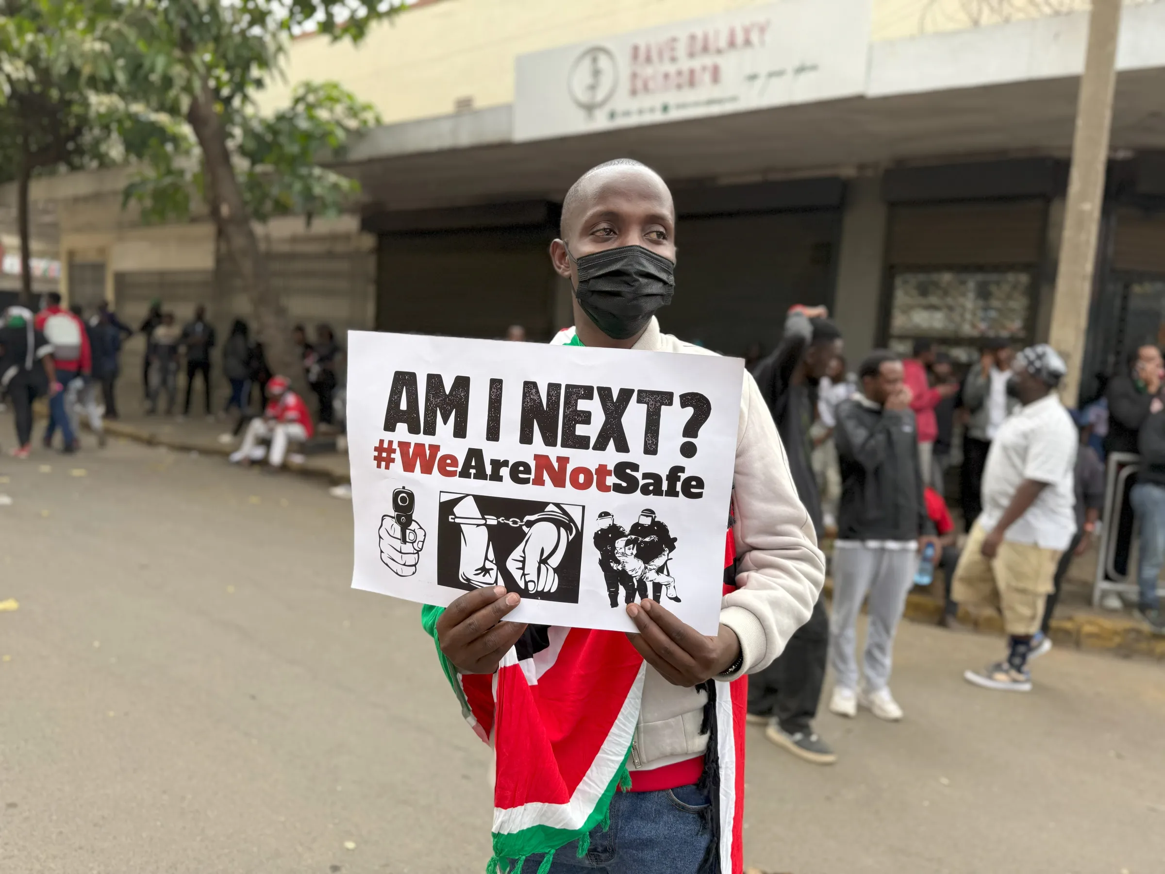 A Kenyan protestor holds up a banner against police brutality at demonstrations in Nairobi on June 25, 2025. THOMSON REUTERS FOUNDATION/Nita Bhalla