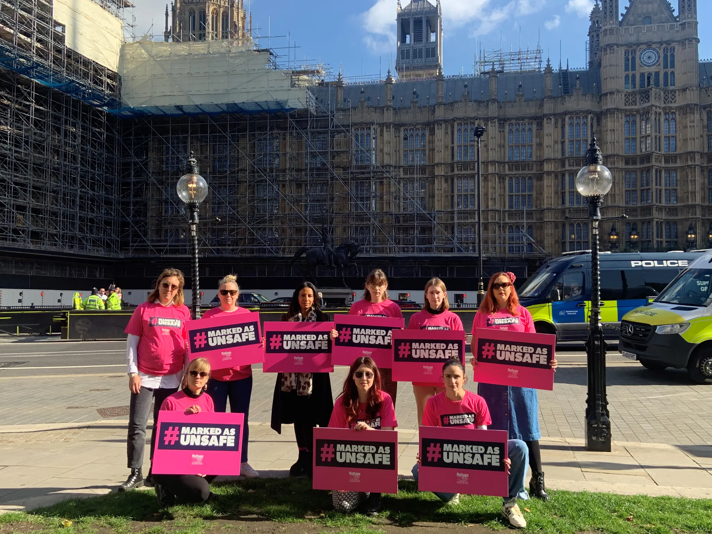 Campaigners from the domestic abuse charity Refuge gather outside the Houses of Parliament in London, Britain. October 11, 2022. Refuge launched a campaign calling for more protections against online violence against women to be included in the Online Safety Bill. Thomson Reuters Foundation/Beatrice Tridimas