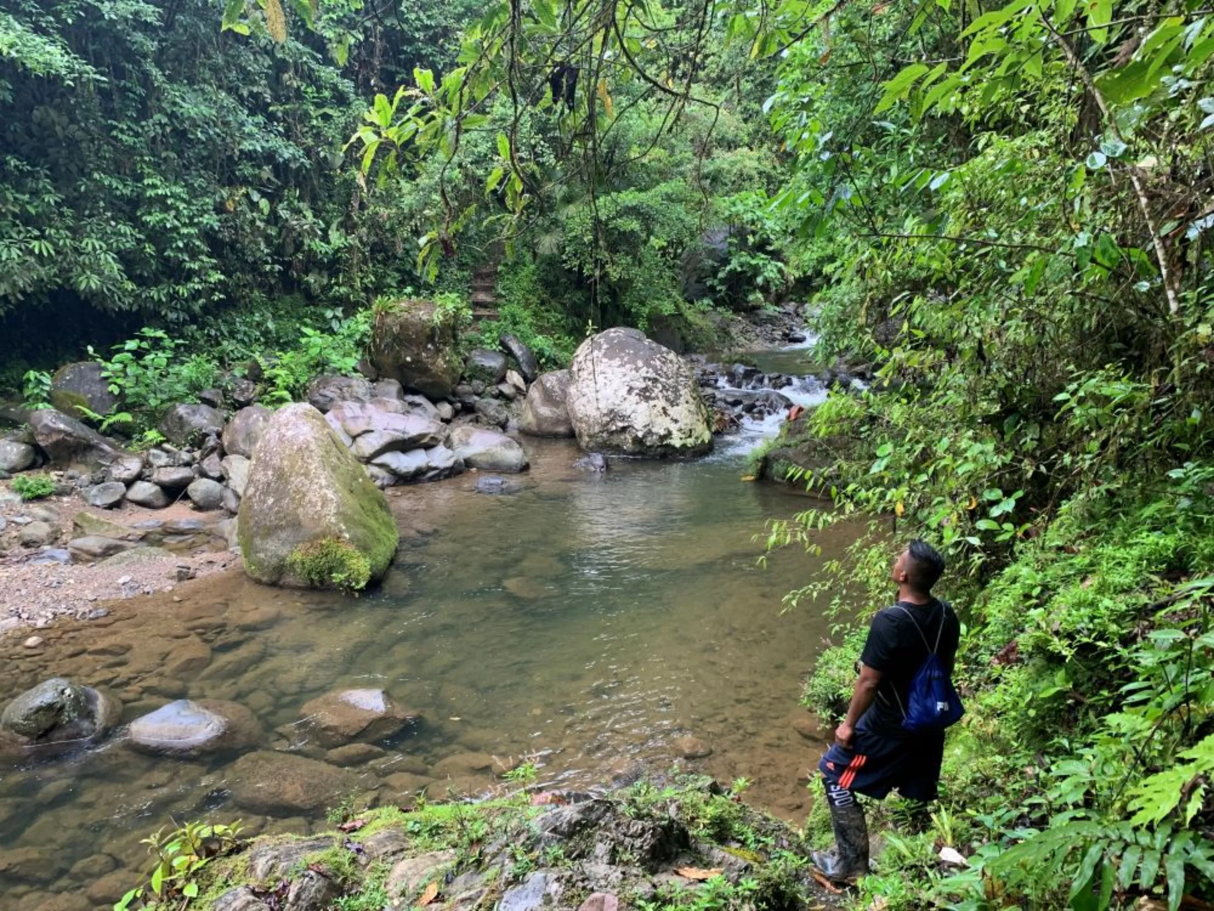Indigenous guide Osvaldo Martinez prepares to cross a stream in the Nairi-Awari territory, Costa Rica, November 6, 2022. The territory straddles on the 174-mile Camino de Costa Rica footpath, that starts in Barra de Pacuare and finishes in Quepos, on the Pacific