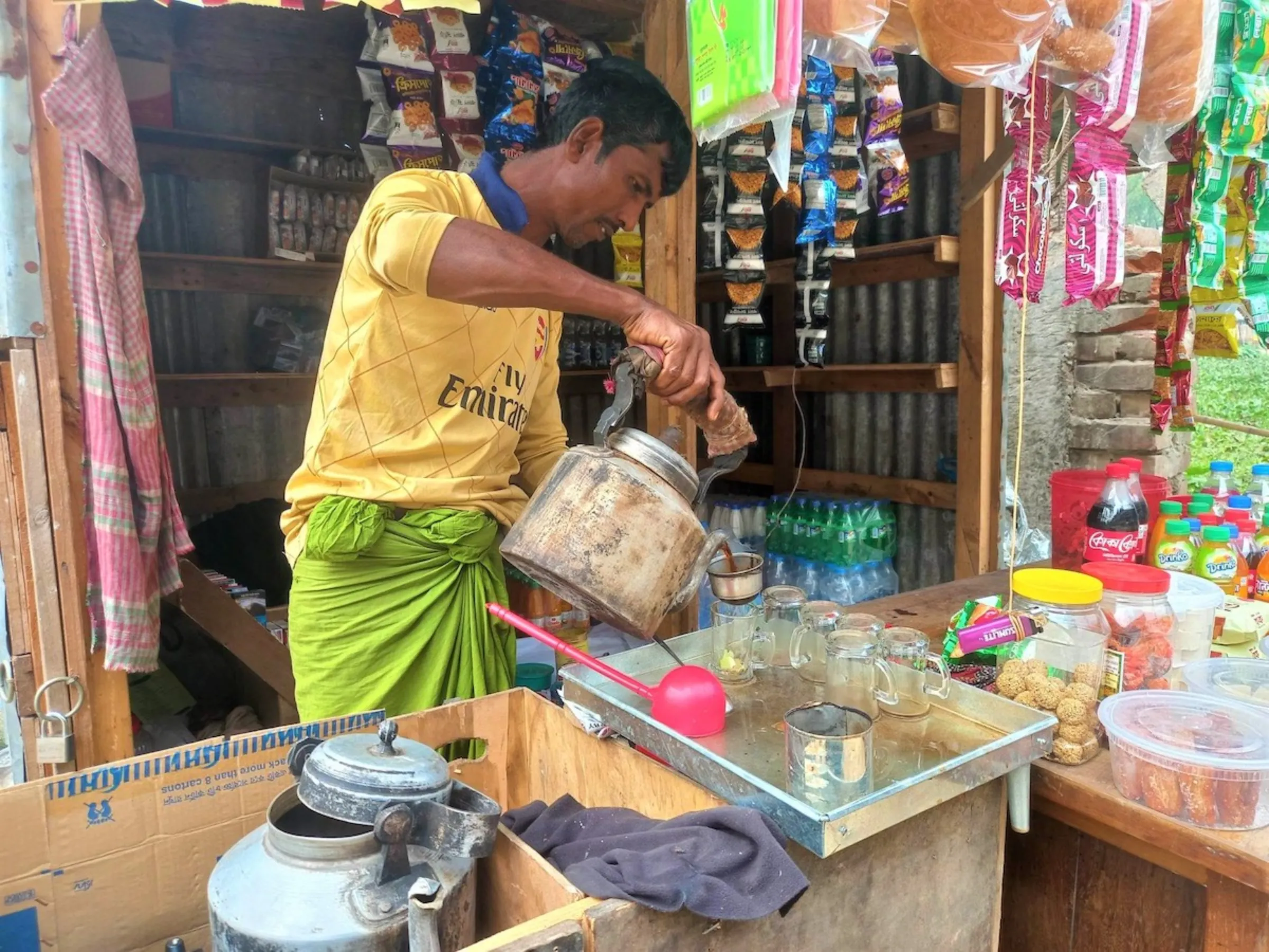 Mohammad Badal, 39, runs a tea stall beside the metro station to provide for his family and pay off his debt in Dhaka, Bangladesh, February 1, 2023. Thomson Reuters Foundation/Md. Tahmid Zami