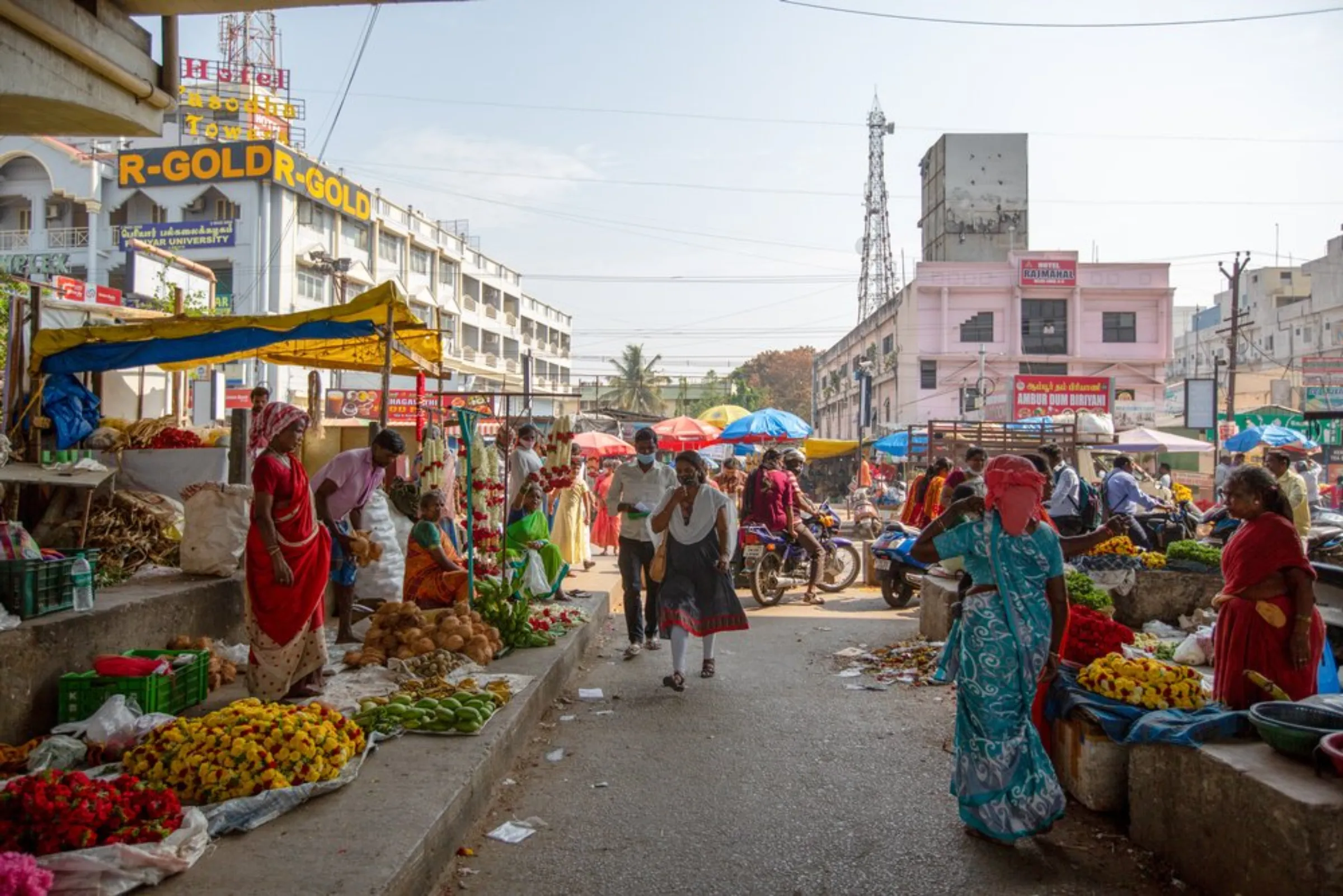 Street vendors hawk their wares on a busy street in Hosur, India, April 20, 2022