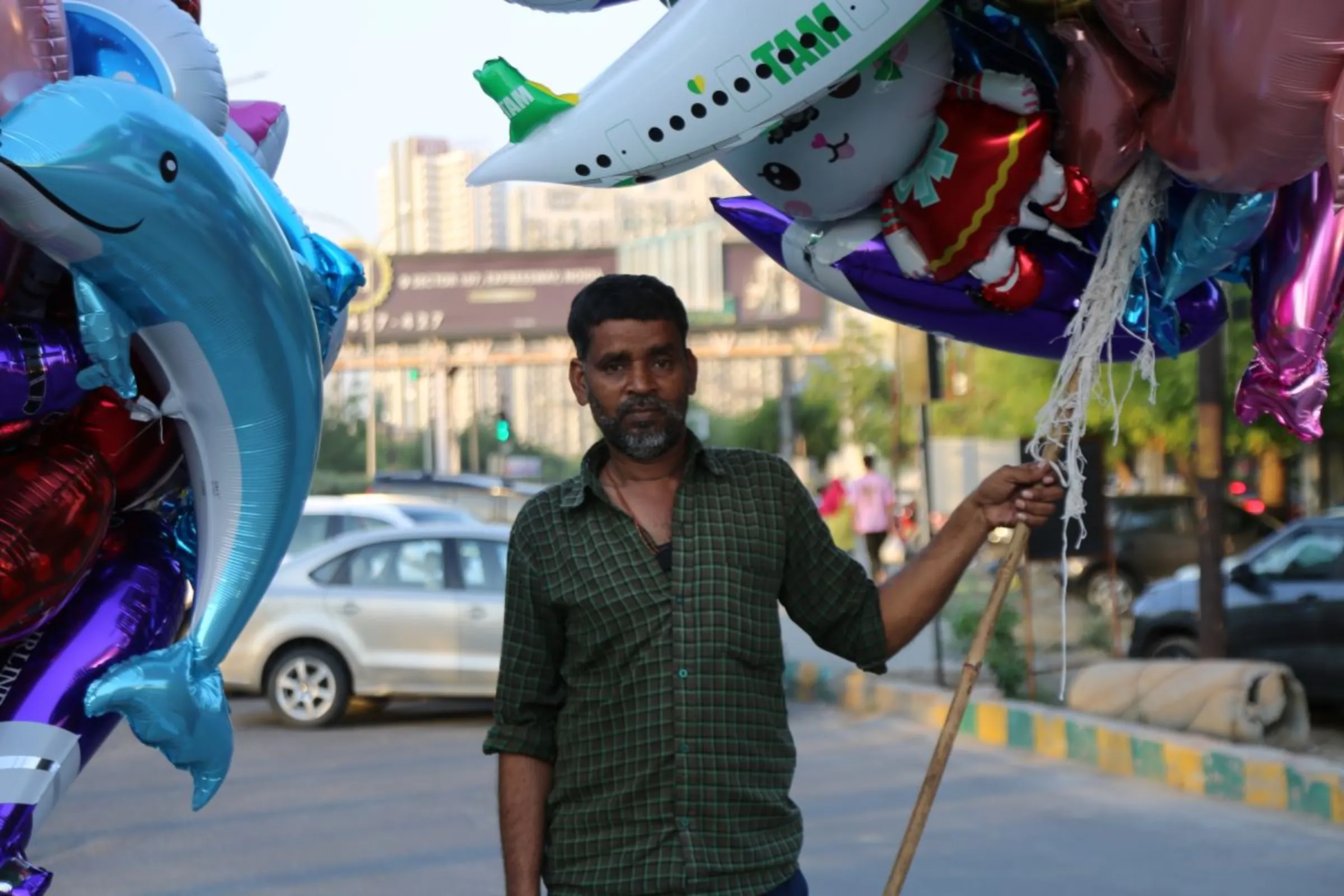 Mohammad Salim, a balloon seller, will go back to his home district a few hours away to vote in May, Noida, India, April 24, 2024. Thomson Reuters Foundation/Annie Banerji