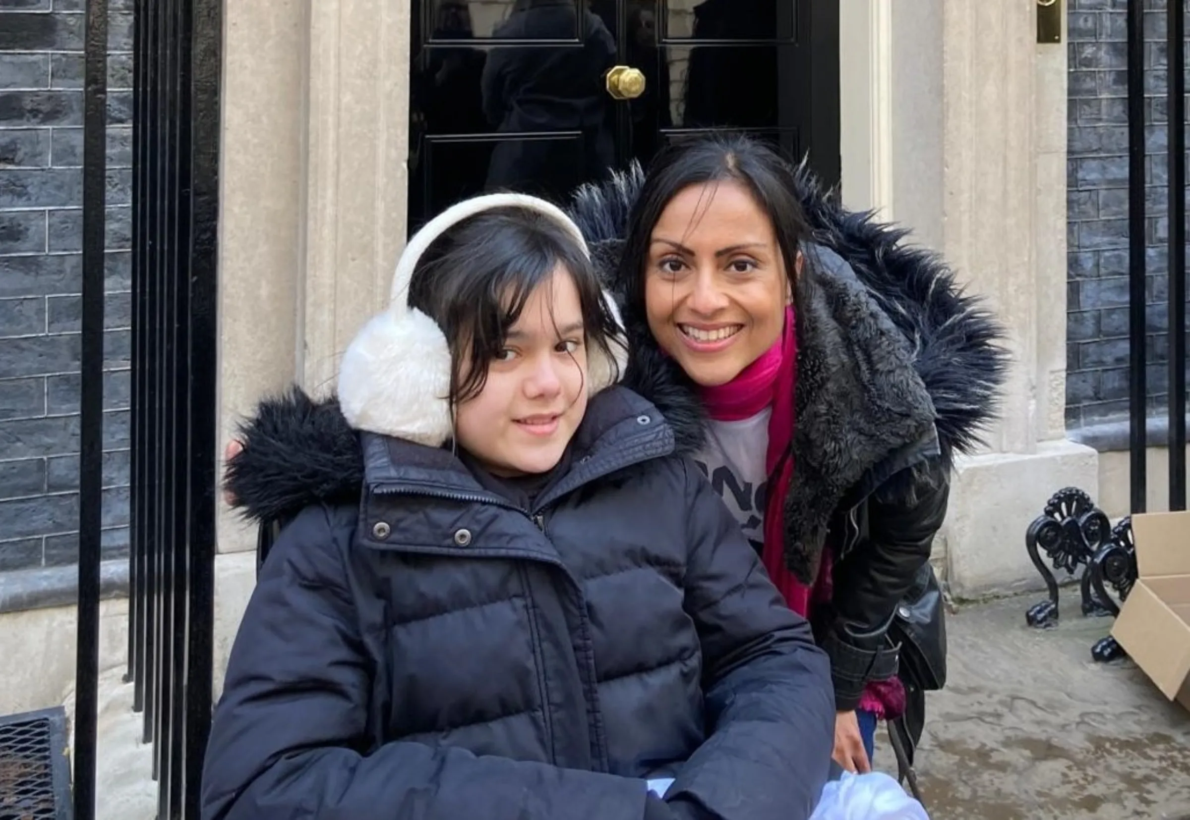 Binita Kane and daughter Jasmin are pictured outside the prime minister's 10 Downing Street residence in April 2022 after delivering a letter to then PM Minister Boris Johnson to raise awareness of long COVID. Binita Kane/Handout via Thomson Reuters Foundation