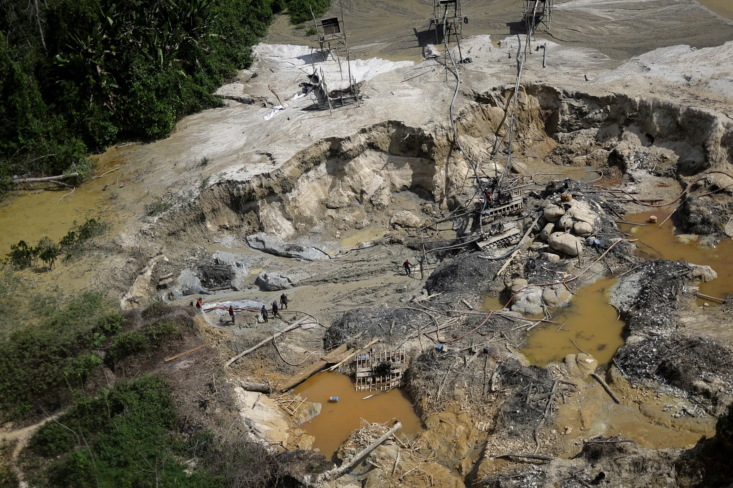 Illegal miners are caught using jets of water to dig for gold, damaging the soil, during an operation against illegal mining in Yanomami Indigenous land, Roraima state, Brazil, December 3, 2023. REUTERS/Ueslei Marcelino