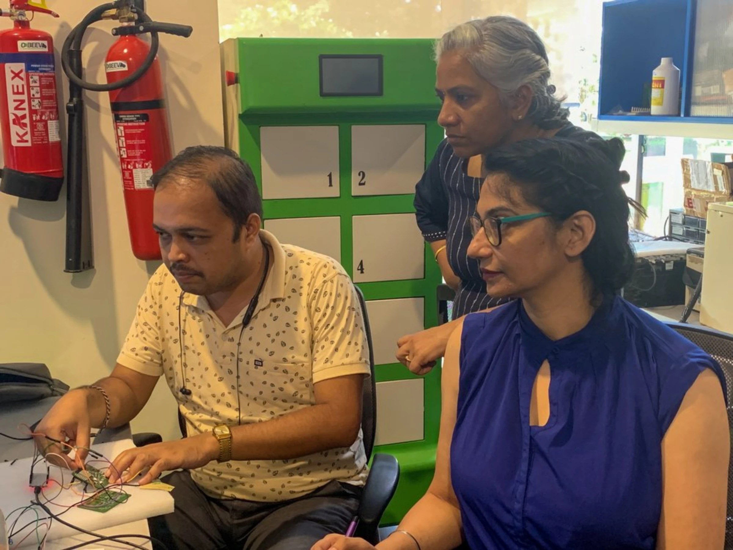 Prabhjot Kaur (R), co-founder and CEO of Esmito Solutions, at work in her office in Chennai, India, April 11, 2022