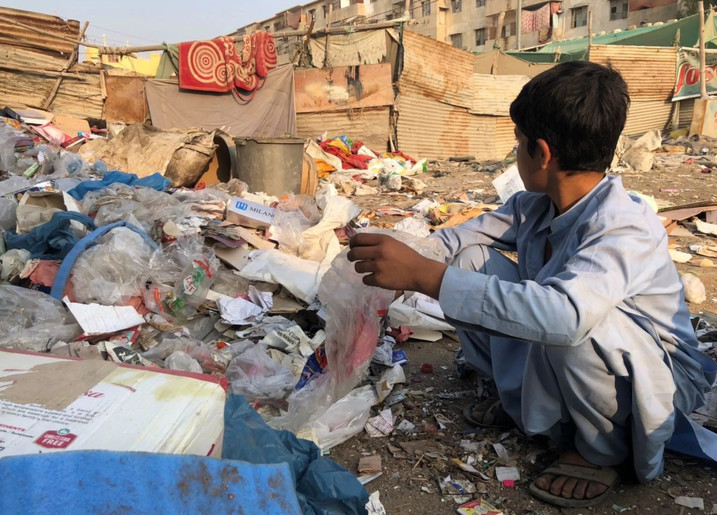 A 15-year-old undocumented rag picker is pictured behind Al-Asif Square, in the Malir district of Karachi, Pakistan, November 8, 2023