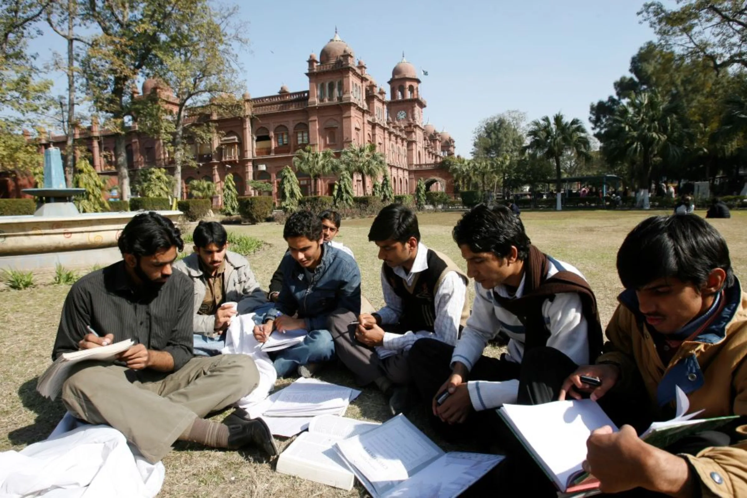 Students exchange their notes after attending a class at Pakistan's Punjab University in Lahore February 12, 2008