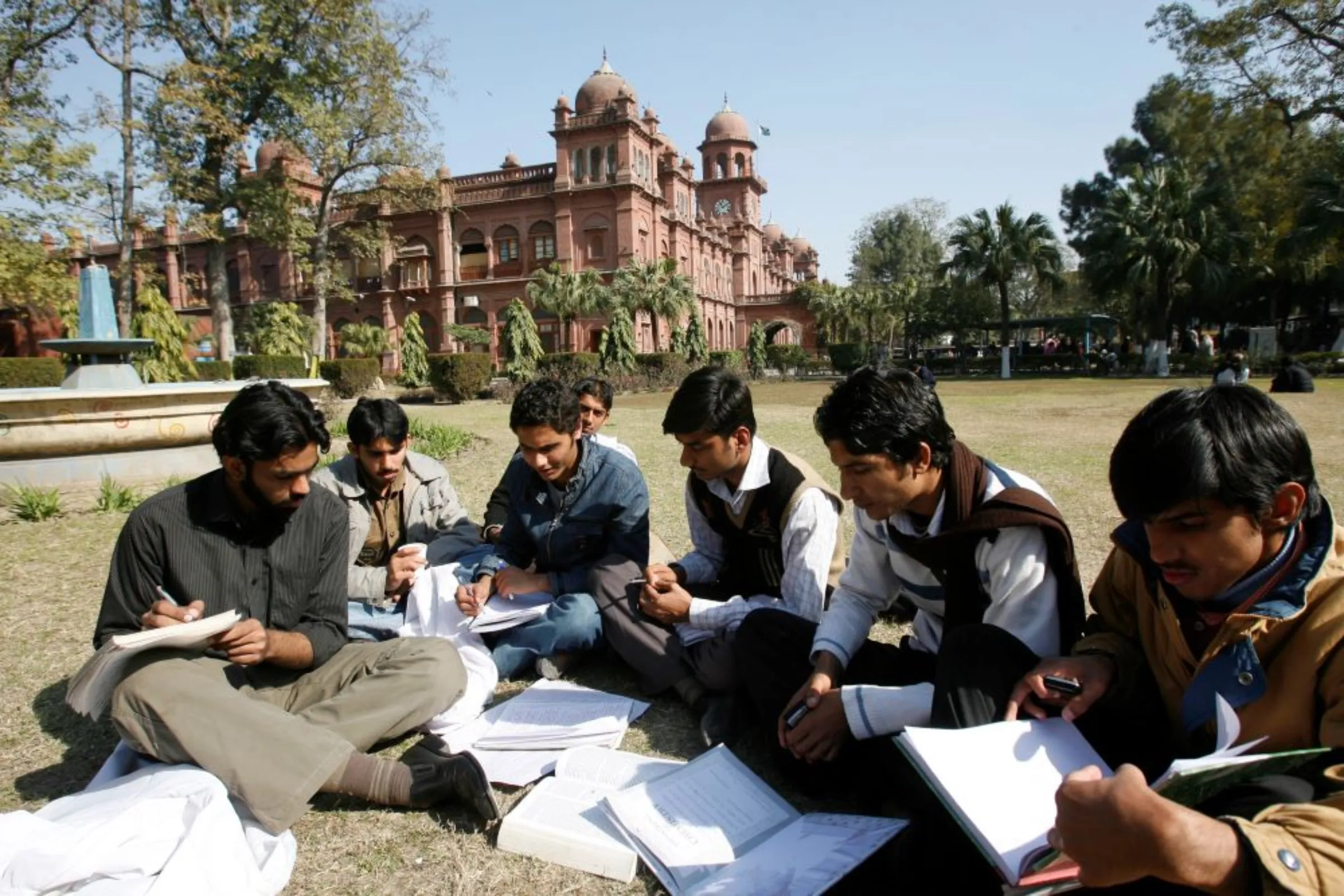 Students exchange their notes after attending a class at Pakistan's Punjab University in Lahore February 12, 2008