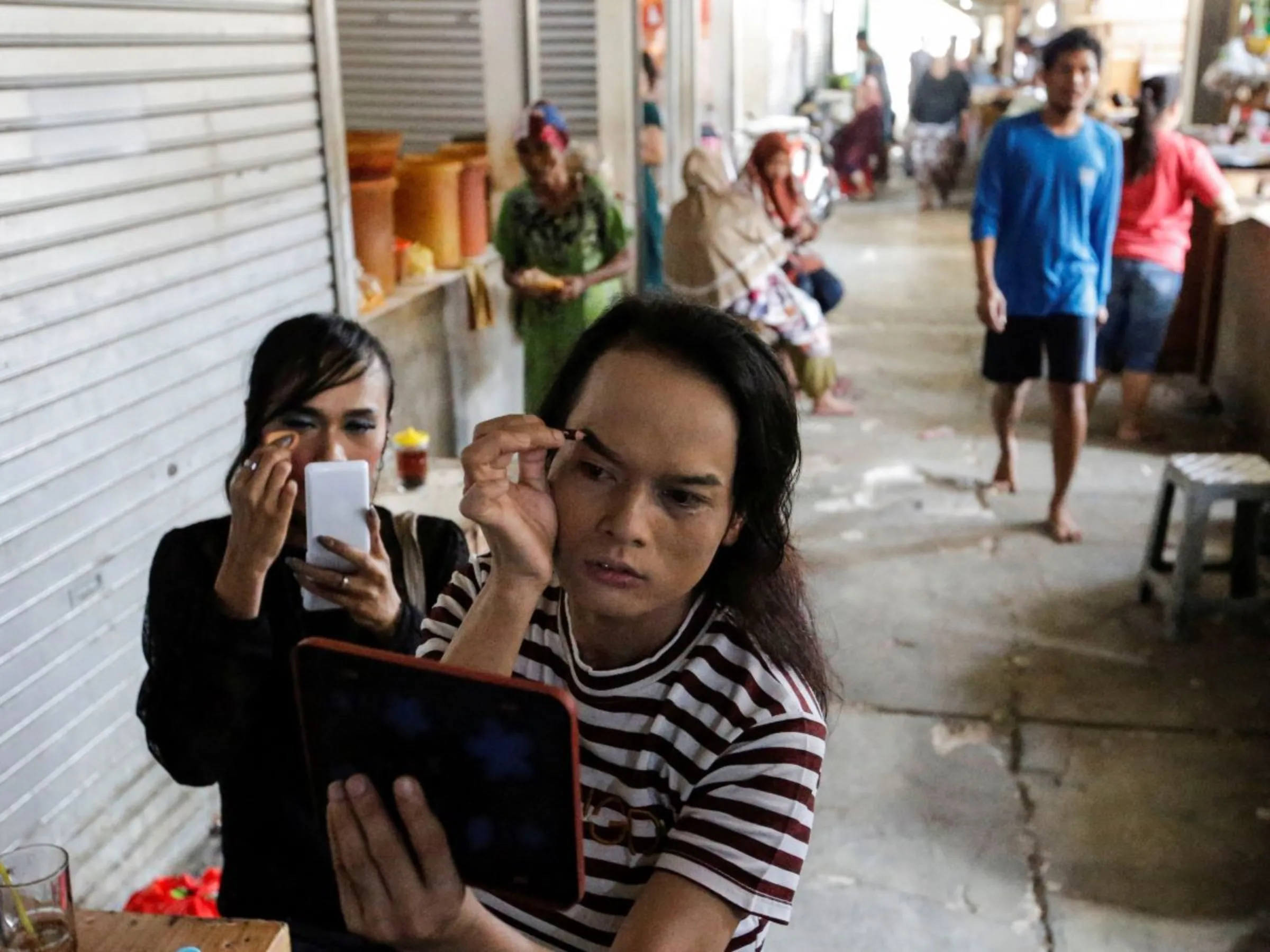 Trans women prepare before a Trans Super Heroes fashion show at a traditional market in Jakarta, Indonesia, December 17, 2023. REUTERS/Ajeng Dinar Ulfiana