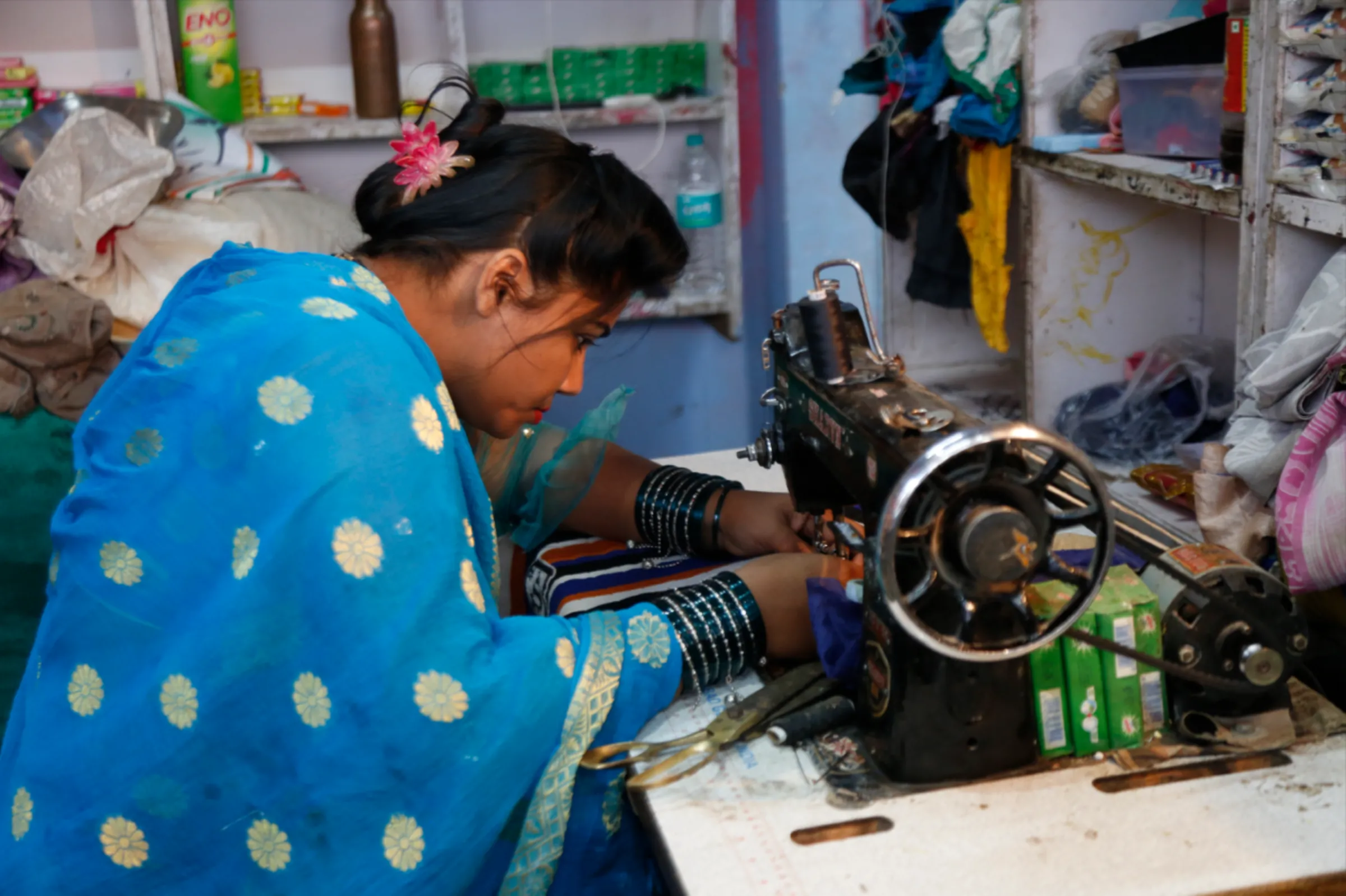 Mithilesh Yadav mends a shirt at her home-based tailor shop, which she started with the help of a microloan, in Bhopal, Madhya Pradesh, November 10, 2022