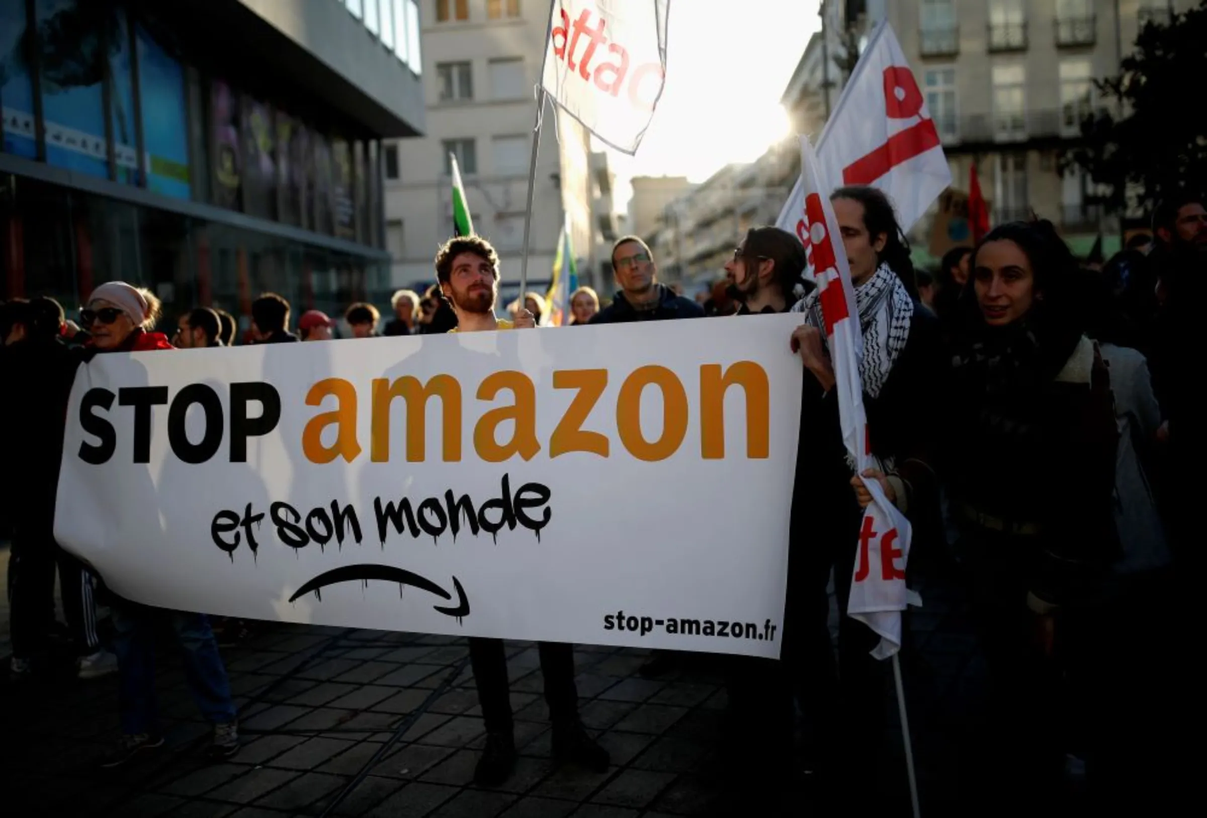 Anti-globalisation movement Attac activists hold a banner that reads: 'Stop Amazon and his world' as they demonstrate during a day of protest to denounce the annual Black Friday shopping frenzy in Nantes, France, November 29, 2019