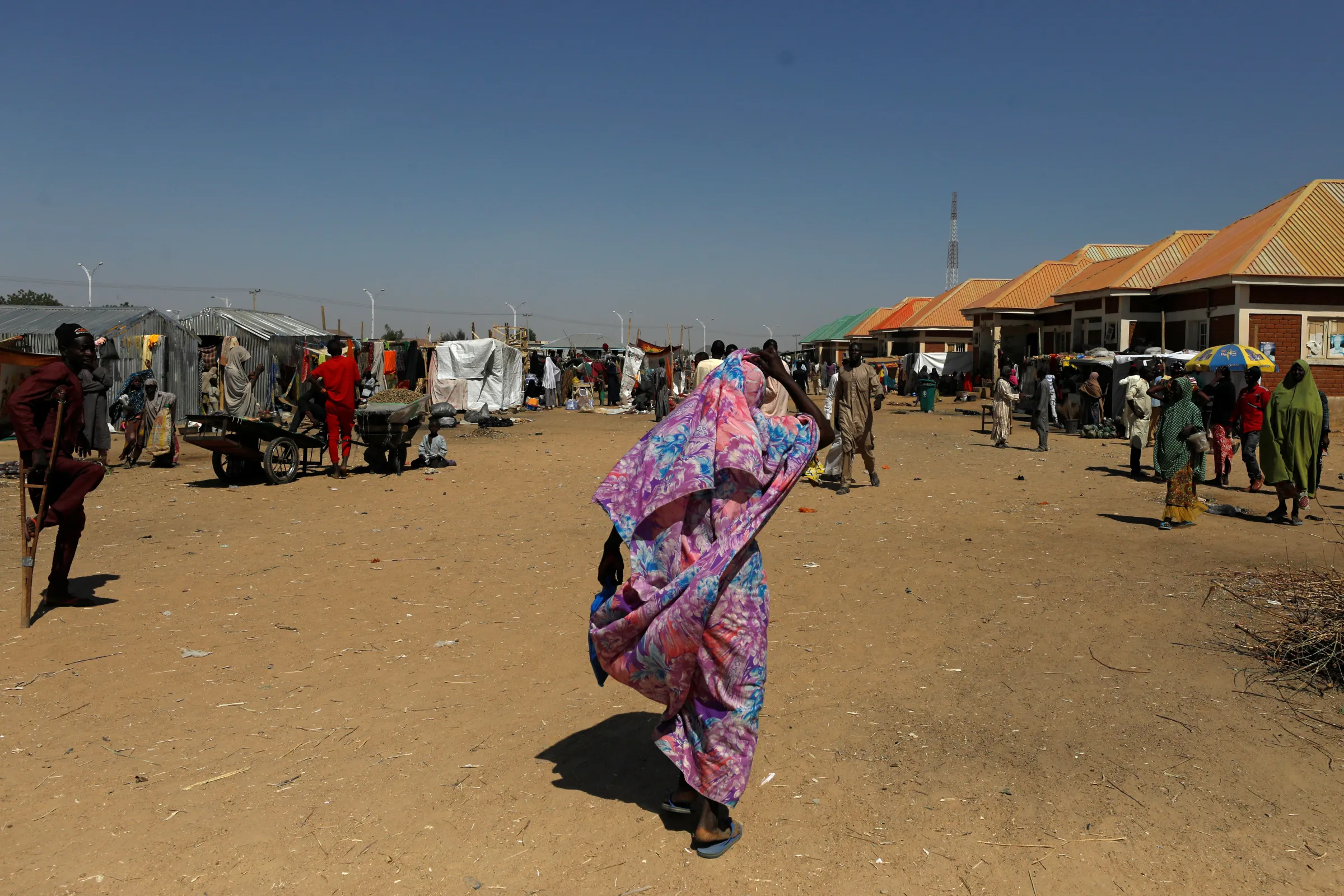 A woman walks at the Teachers' Village IDP camp in Maiduguri