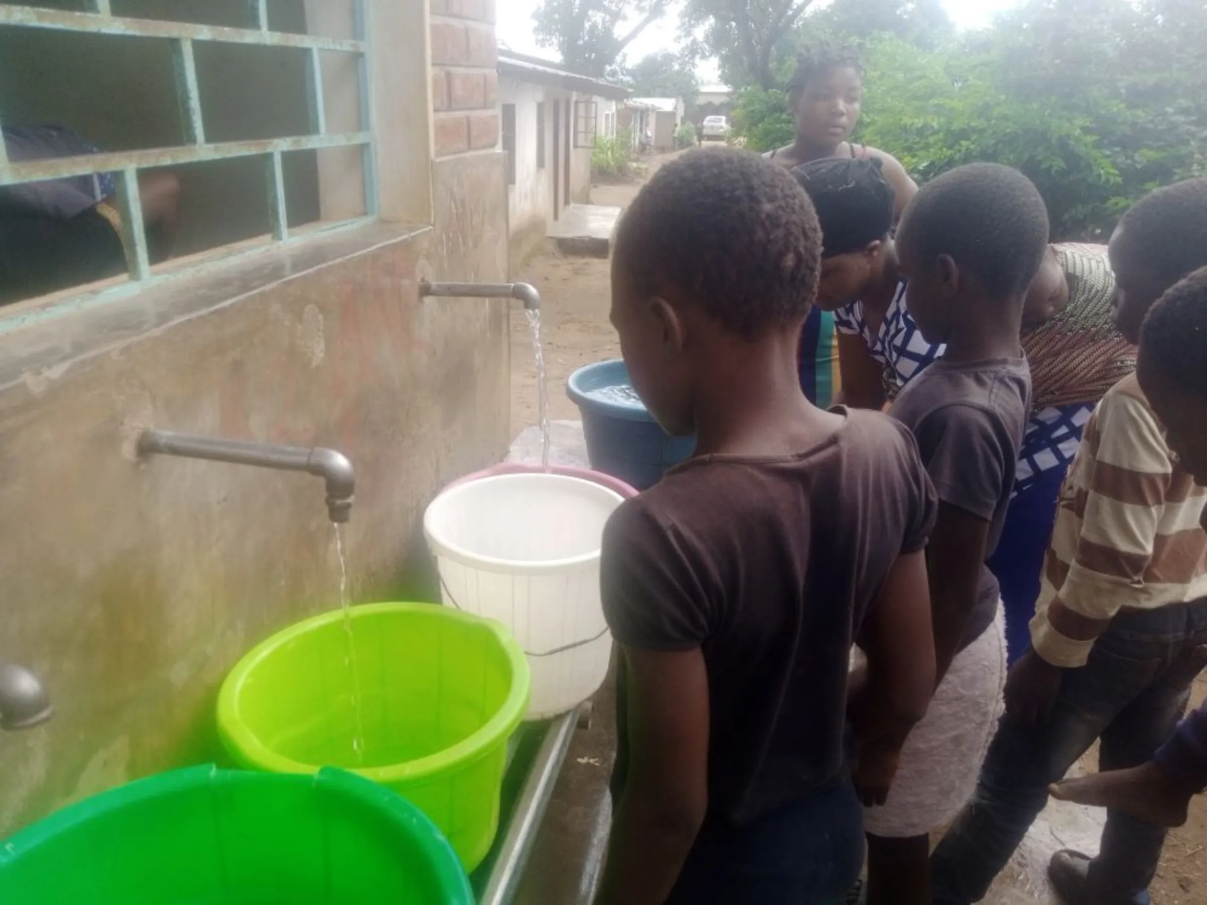 Residents in Makhetha Township draw water from Kiosks after weeks of no running water, Malawi. January 11, 2023.