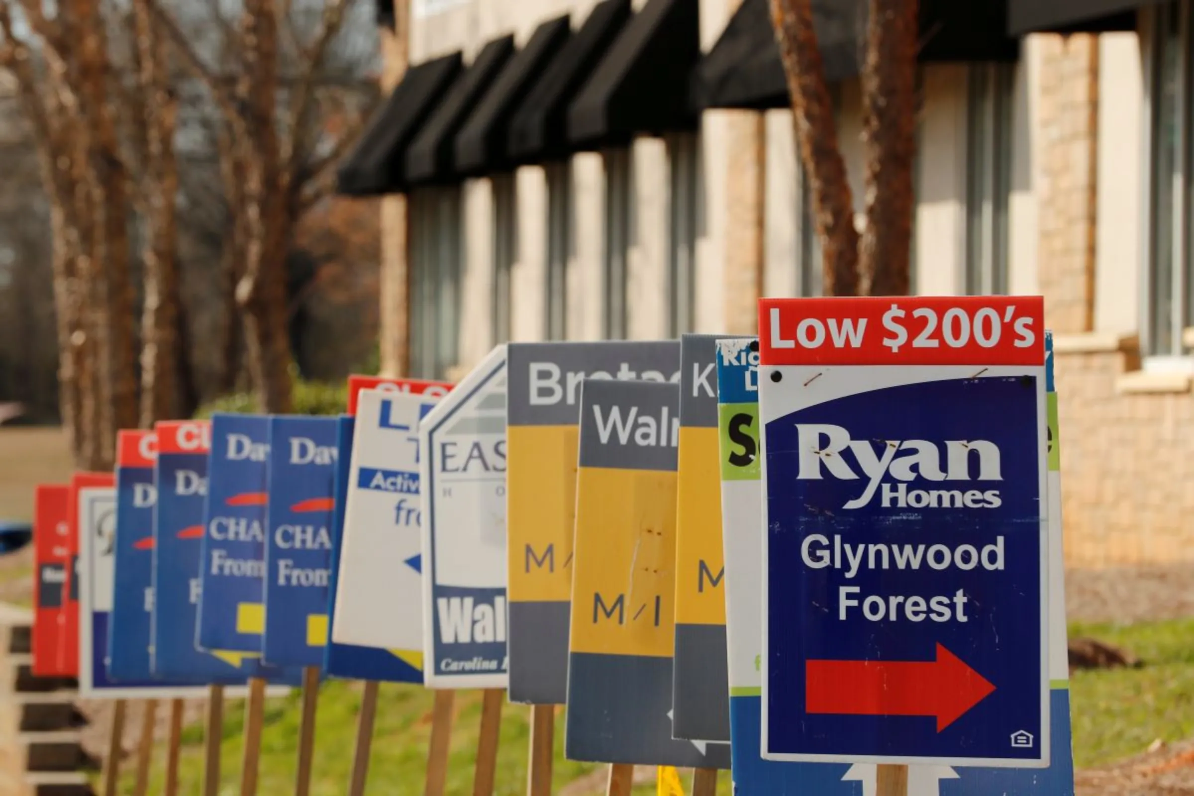 Real estate signs advertise new homes for sale in multiple new developments in York County, South Carolina, U.S., February 29, 2020. REUTERS/Lucas Jackson