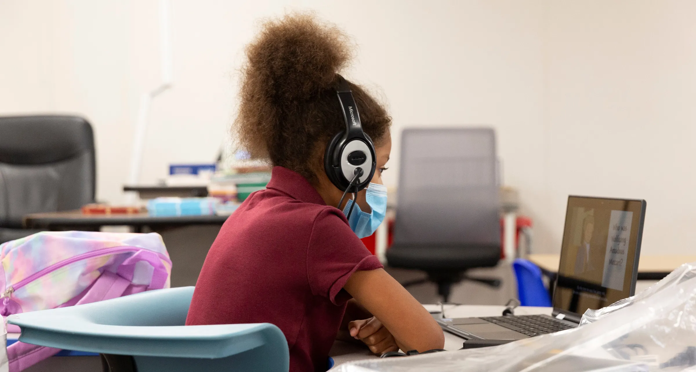 A student attends a virtual class while monitored by instructional assistants as in-person learning resumes with restrictions in place to prevent the spread of coronavirus disease (COVID-19) at Wilson Primary School in Phoenix, Arizona, U.S., August 17, 2020