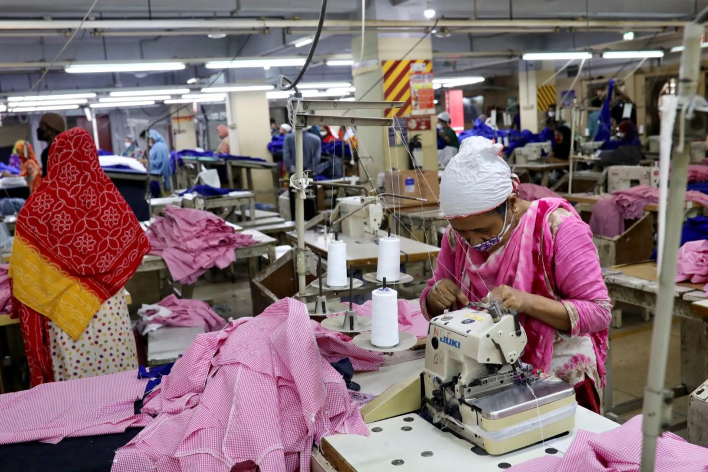 Women work in a garment factory, as factories reopened after the government has eased the restrictions amid concerns over coronavirus disease (COVID-19) outbreak in Dhaka, Bangladesh, May 3, 2020. REUTERS/Mohammad Ponir Hossain