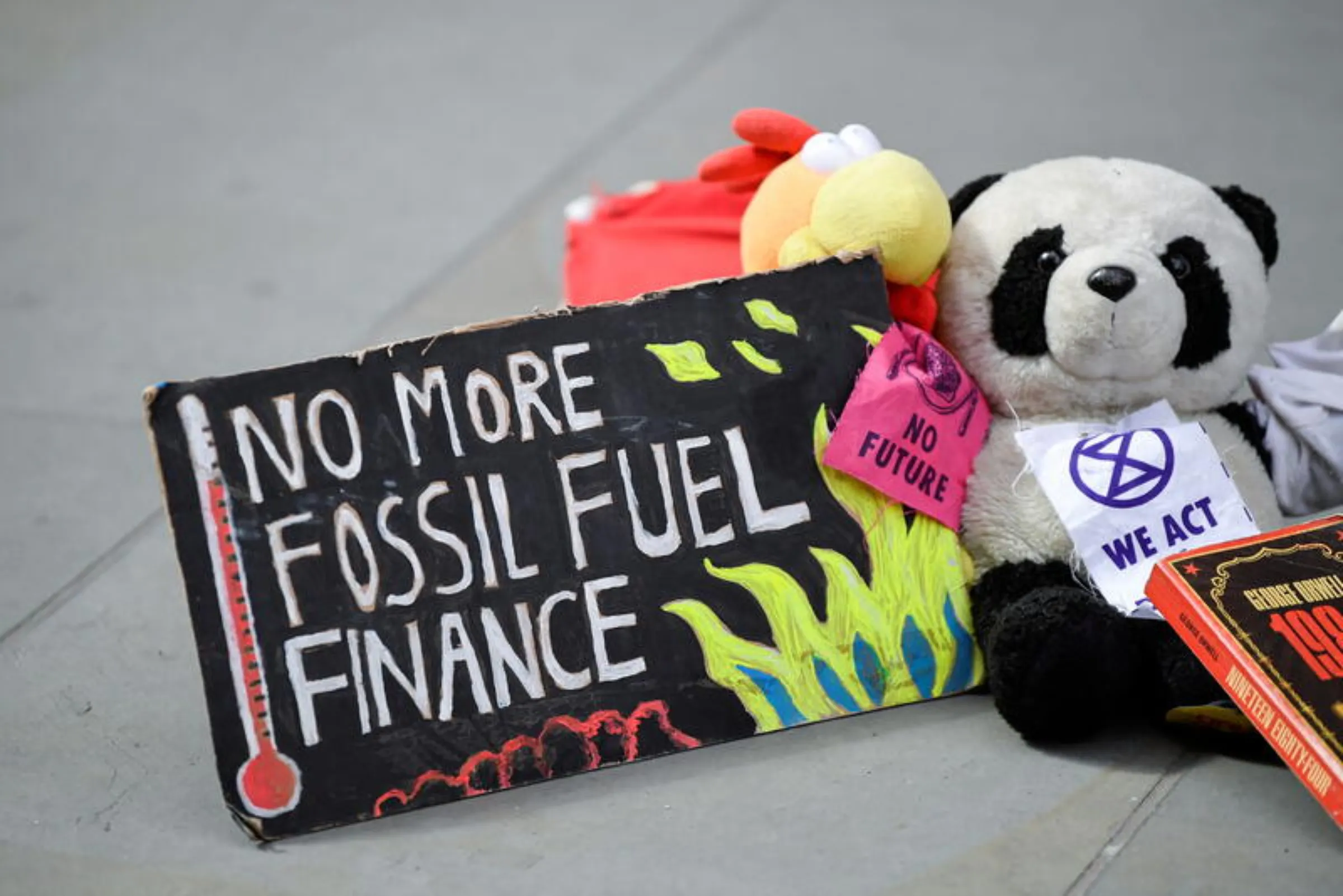 A sign lies on the ground as members of Extinction Rebellion stage a protest against the use of and investment in fossil fuels, on Earth Day in the City of London, Britain, April 22, 2022. REUTERS/Toby Melville