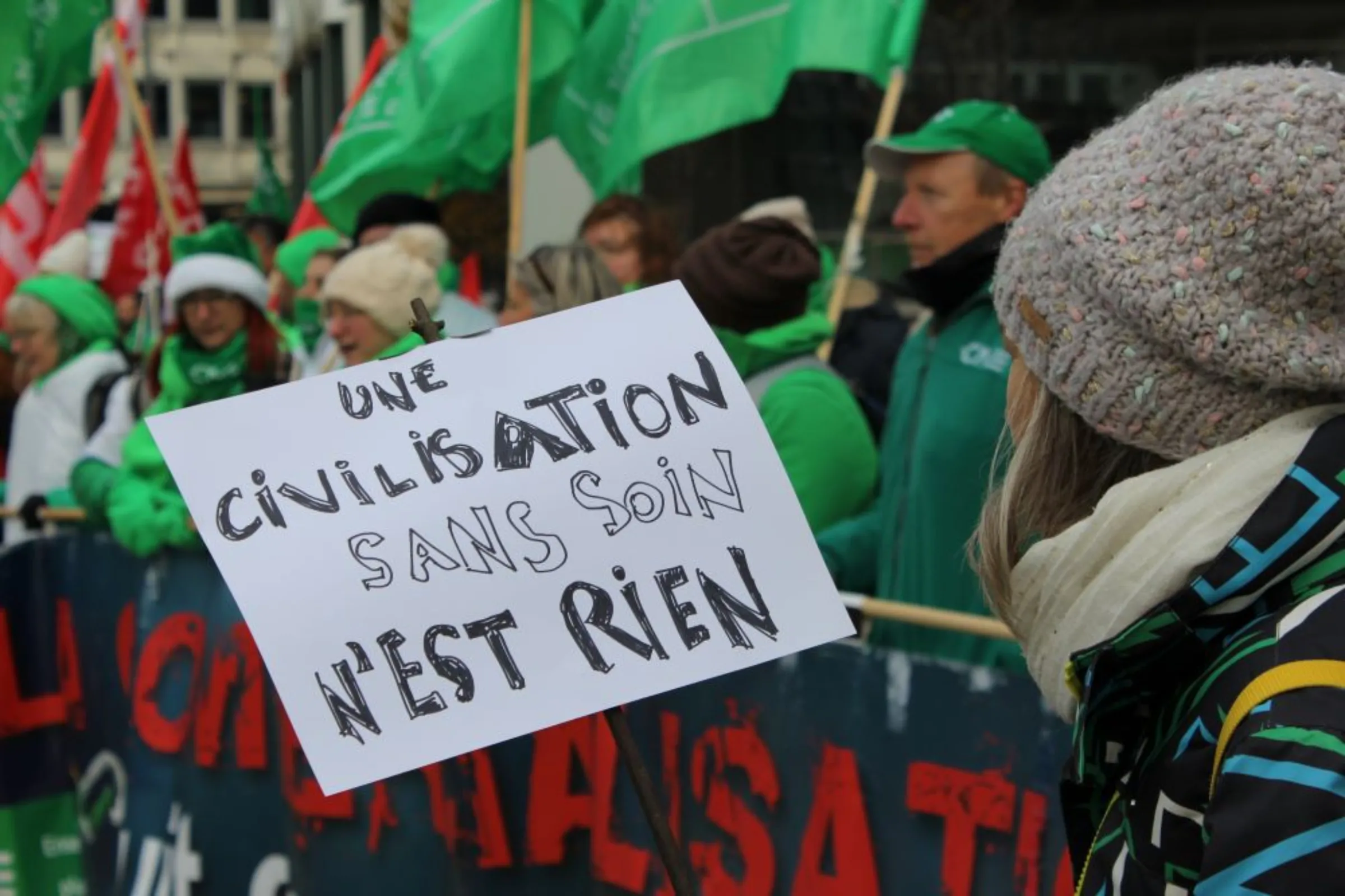 Banner reads 'a society without healthcare is nothing' at demonstration of healthcare workers in Brussels, Belgium December 9 2022. Thomson Reuters Foundation/ Joanna Gill