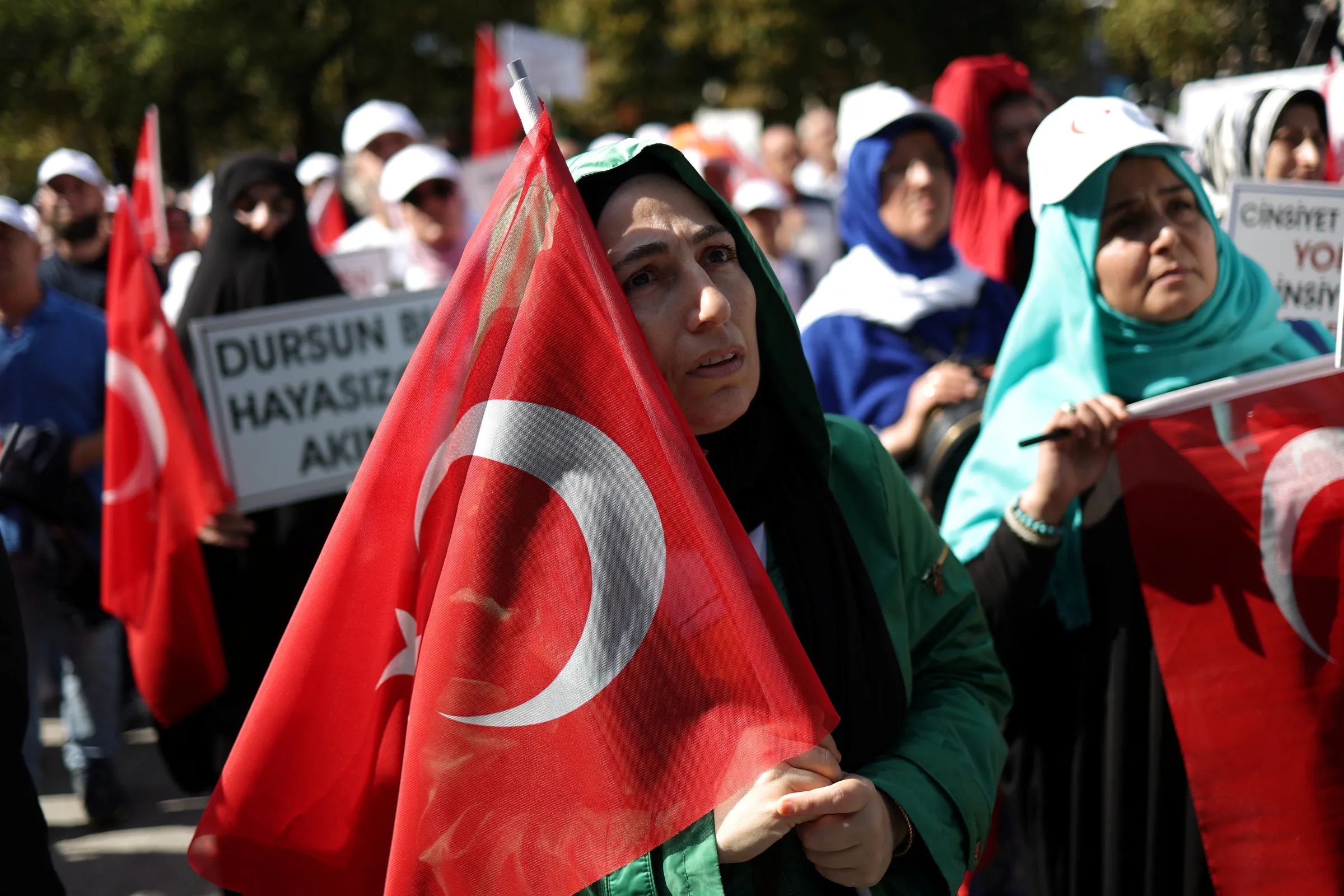 A woman holds a Turkish flag, as people take part in 'Big Family Gathering', an anti-LGBT rally, organised by pro-Islamic Big Family Platform in Istanbul, Turkey, September 15, 2024. REUTERS/Murad Sezer