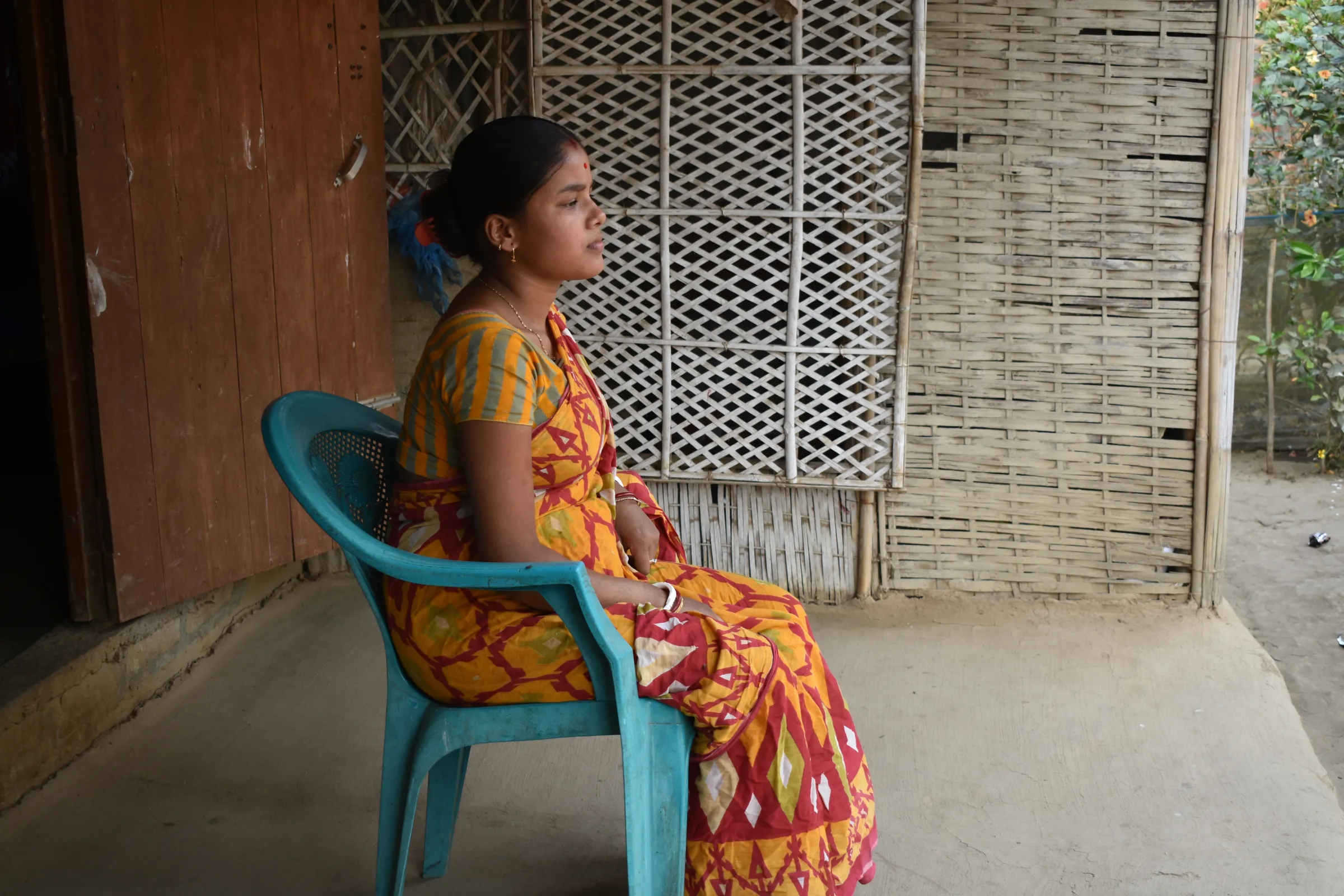 Teenage bride Pinku Das Sarkar, whose husband was arrested in the government crackdown on child marriage, sits outside her house in Radhanagar, India, February 28, 2023