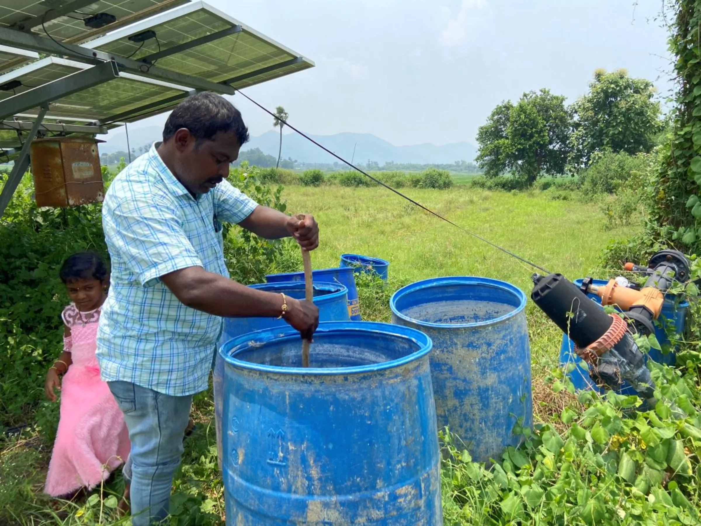 Farmer P. Sabarinath stirs organic manure on his natural farm in Atlapragada Konduru village, Andhra Pradesh state, India, September 1, 2023. Thomson Reuters Foundation/Roli Srivastava