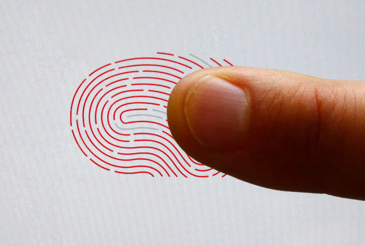A person uses a sensor for biometric identification on a smartphone