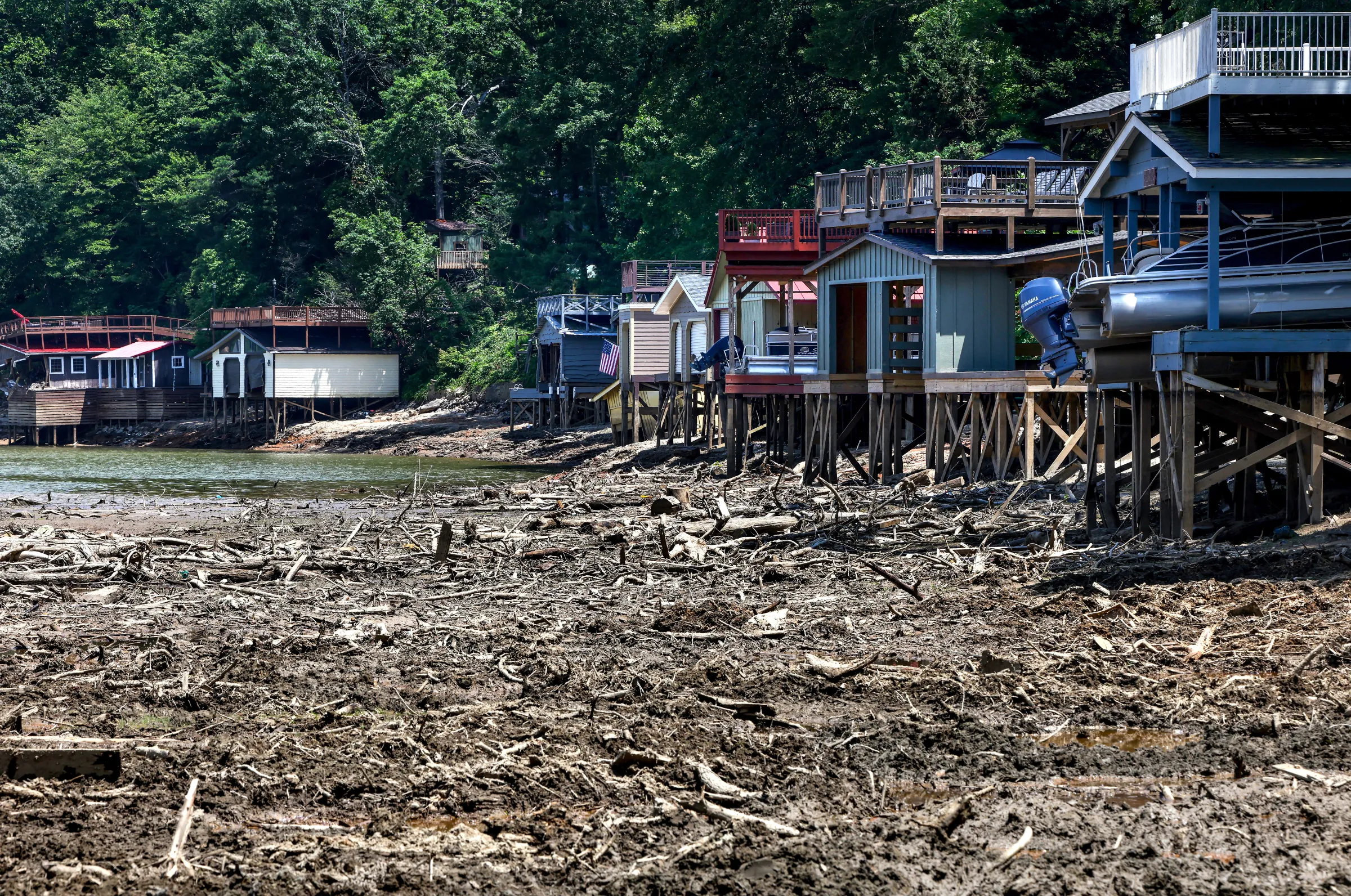Lake homes sit along the dry bed of Lake Lure which has been reduced to a construction zone to extract more than a million cubic yards of debris deposited by Hurricane Helene causing the town’s main attraction to close for the summer and impacting the local economy in Lake Lure, North Carolina, U.S., June 3, 2025. REUTERS/Evelyn Hockstein