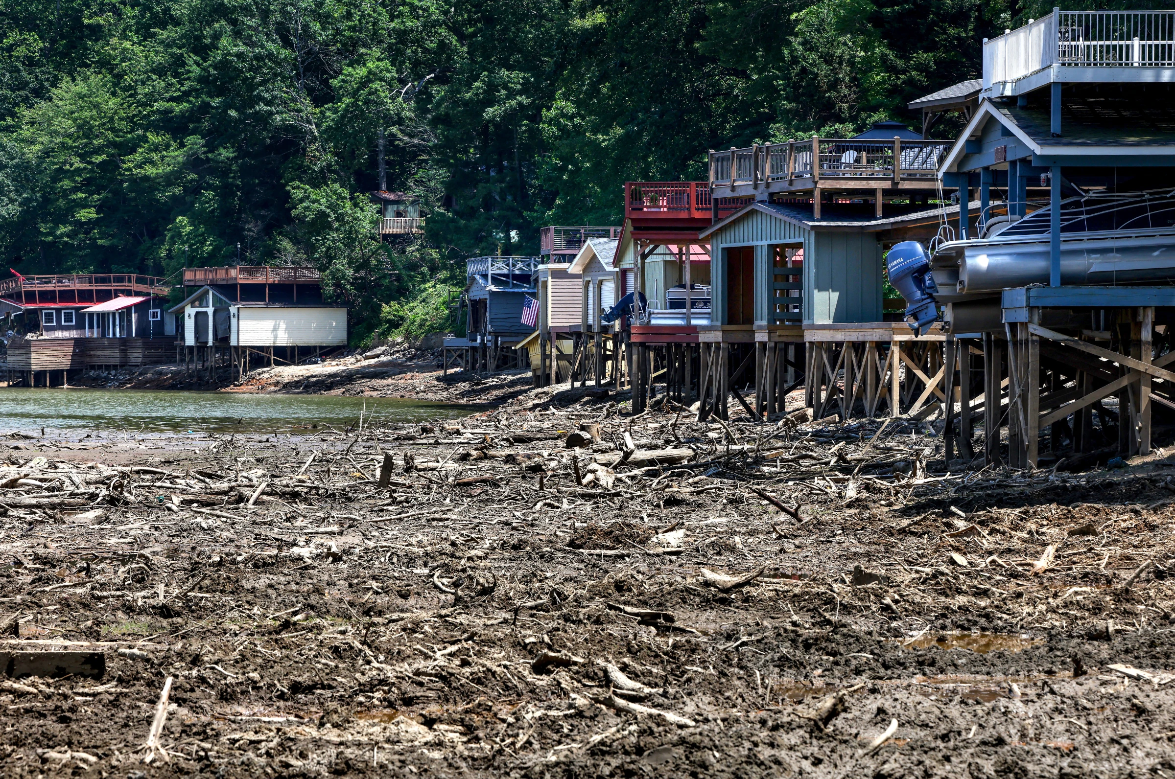 Lake homes sit along the dry bed of Lake Lure which has been reduced to a construction zone to extract more than a million cubic yards of debris deposited by Hurricane Helene causing the town’s main attraction to close for the summer and impacting the local economy in Lake Lure, North Carolina, U.S., June 3, 2025. REUTERS/Evelyn Hockstein