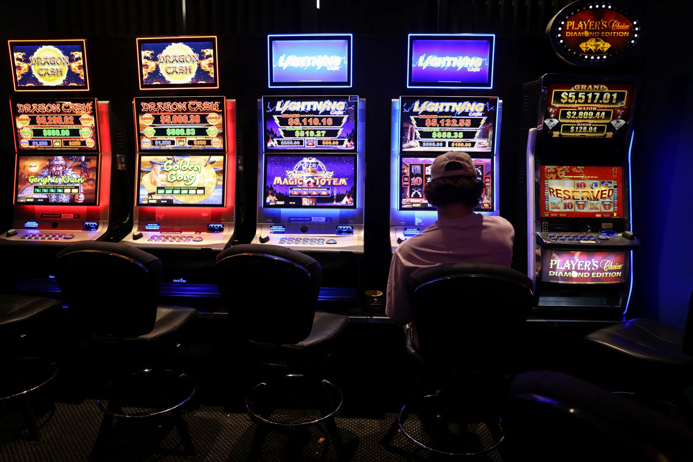 A person gambles on a poker machine at a pub in Sydney, Australia, September 19, 2022. REUTERS/Loren Elliott
