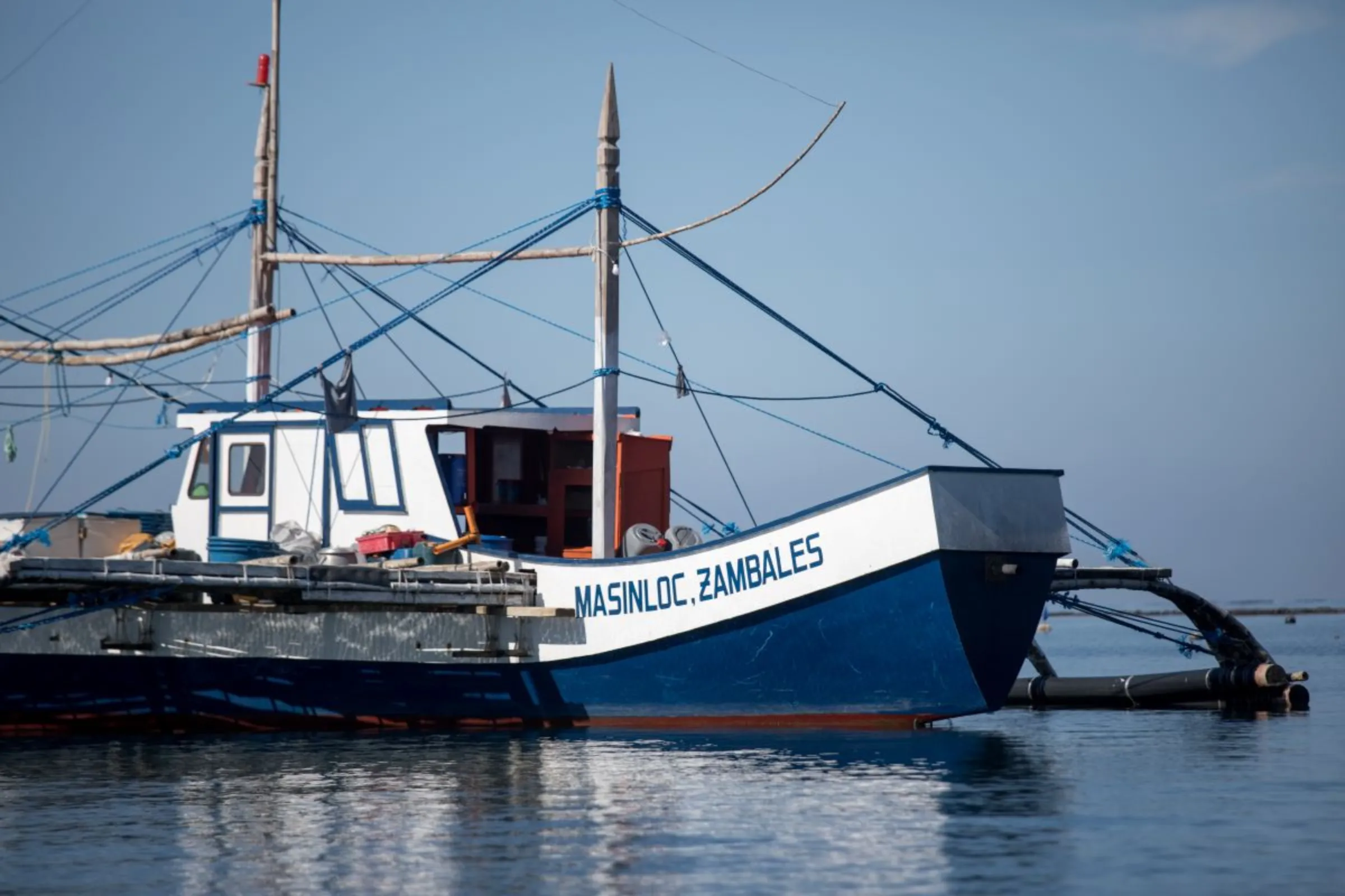 A large vessel used to fish the waters of Scarborough Shoal in the West Philippine Sea lies at anchor on the coast of San Salvador Island in Masinloc, Zambales Province in the Philippines. . Fishermen on the island say China’s attempts to block them from fishing at the Scarborough Shoal is costing them money and threatening their livelihoods. Nov. 16, 2023. Thomson Reuters Foundation/Kathleen Limayo