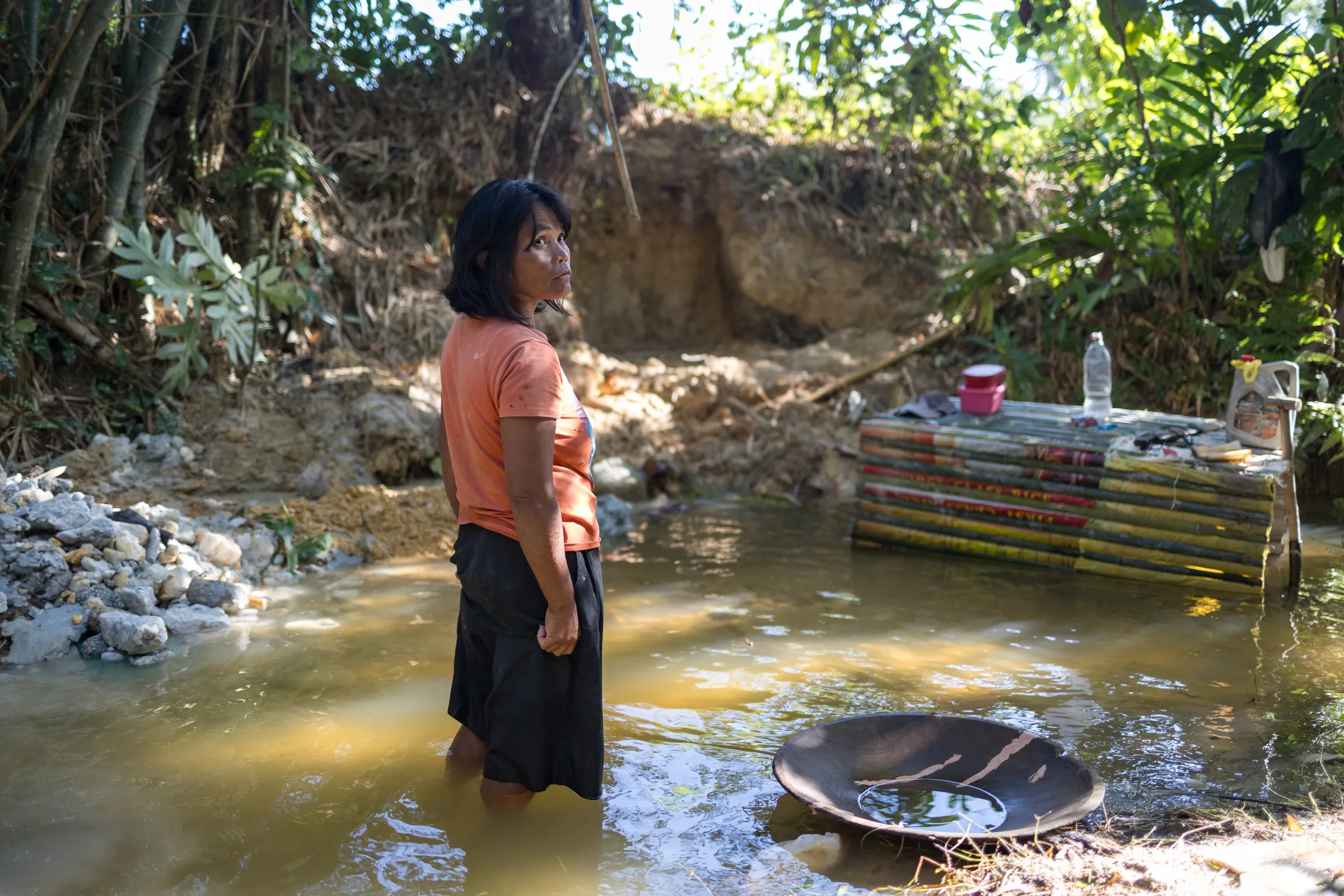 Evelyn Inova sifts through mud in Paracale, Camarines Norte, Philippines, in search of gold during the mining process. March 5, 2024. Thomson Reuters Foundation/Kathleen Lei Limayo