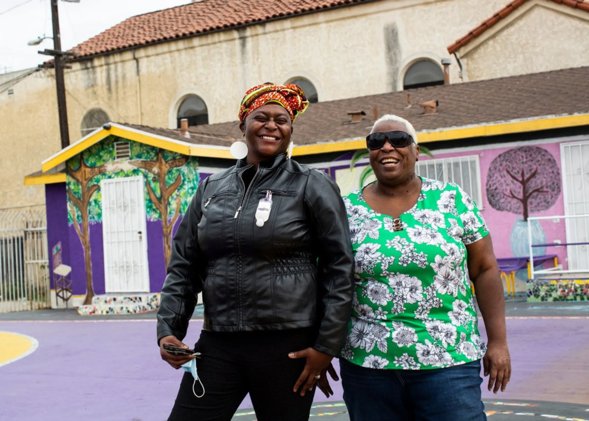 Community environmental justice activists Jaquelyn Badejo (L) and her mother Linda Cleveland (R) stand in their Watts neighborhood in southern Los Angeles, California, May 17, 2021