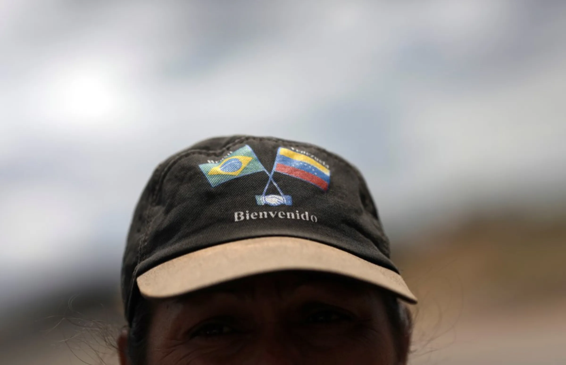 Venezuelan Frank Mendoza wears a cap with Brazilian and Venezuelan national flags that reads 'welcome' in the Brazilian border city of Pacaraima, Roraima state, Brazil February 21, 2019