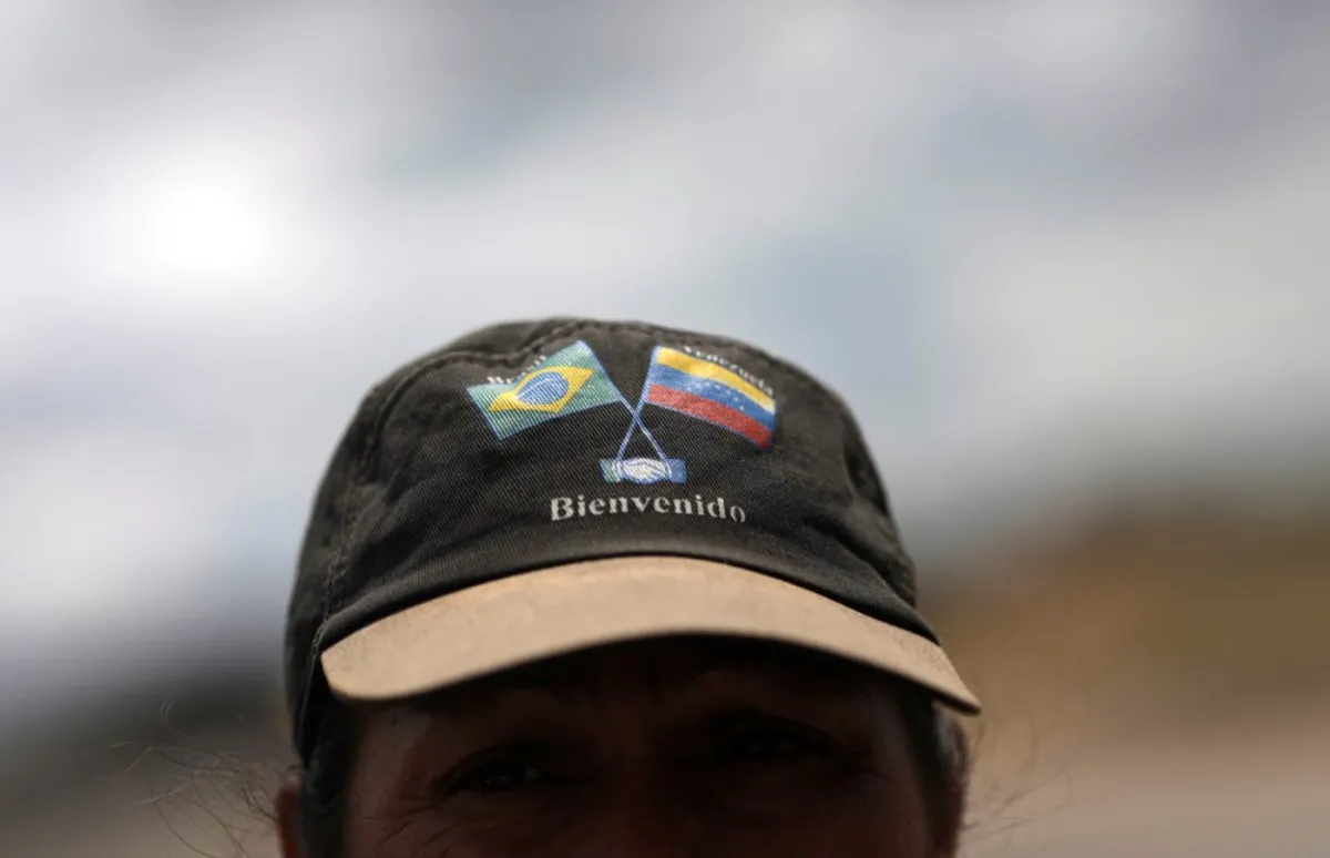 Venezuelan Frank Mendoza wears a cap with Brazilian and Venezuelan national flags that reads "welcome" in the Brazilian border city of Pacaraima, Roraima state, Brazil February 21, 2019
