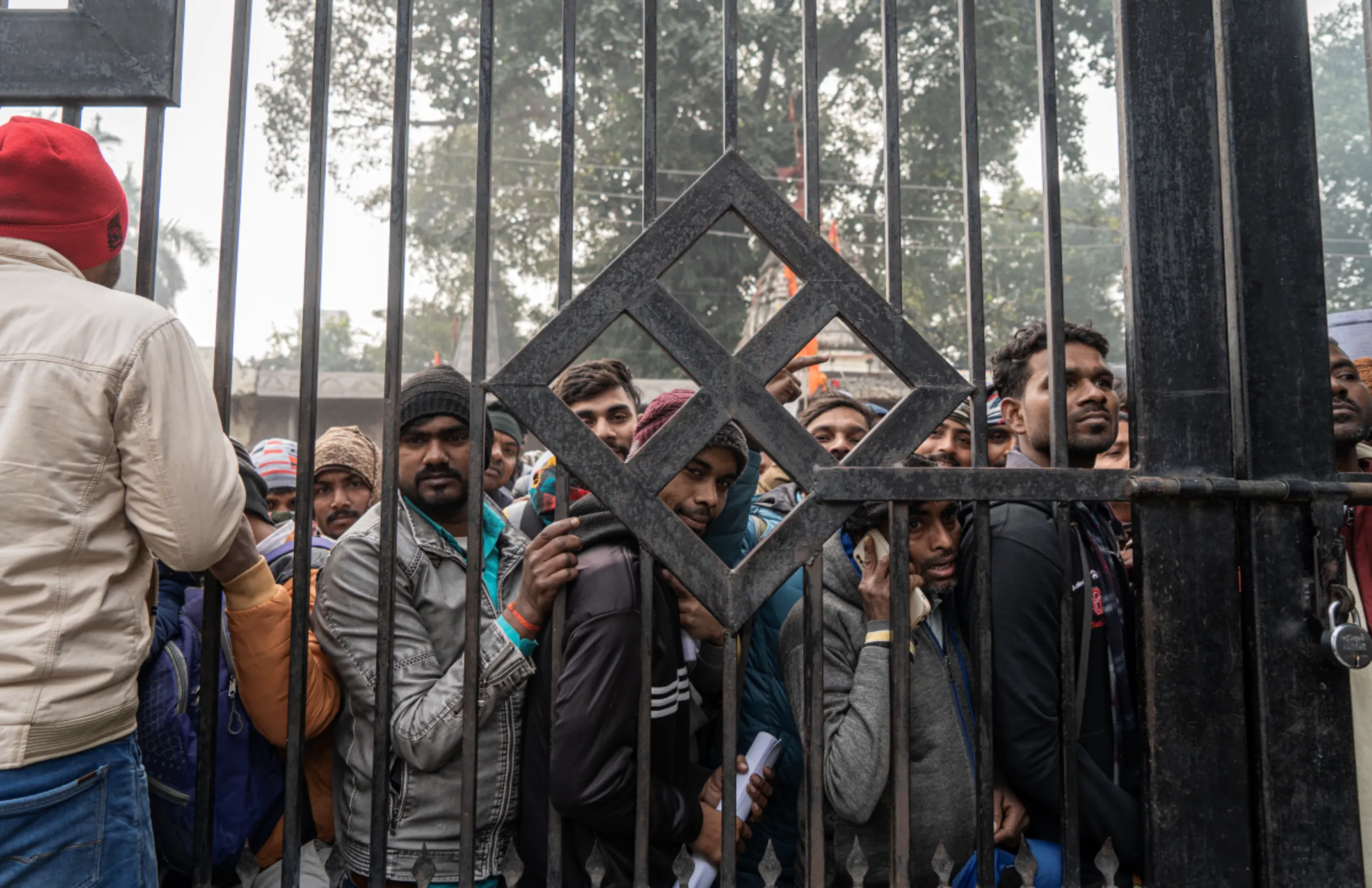 Hundreds of carpenters, bricklayers and painters wait at the gates of the recruitment center in the hope of securing a job in Israel. Thomson Reuters Foundation/Ahmer Khan