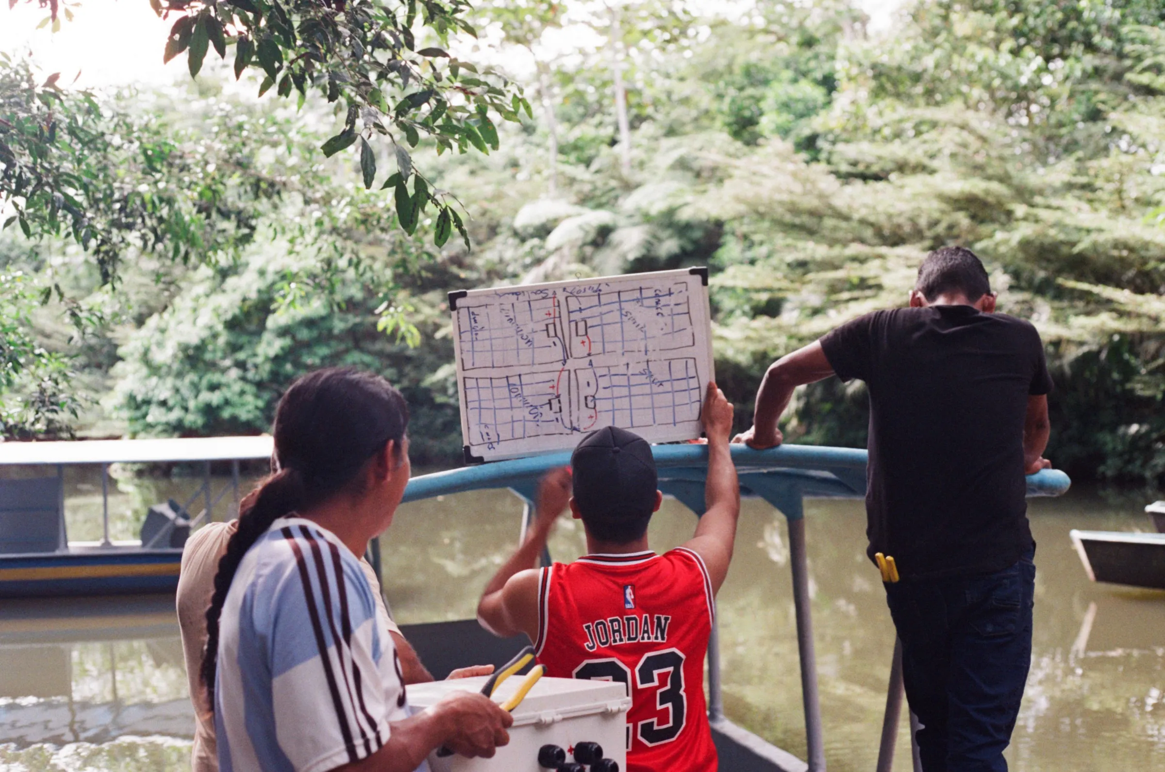 A group of Kara Solar technicians work on a new solar-panel-powered river boat