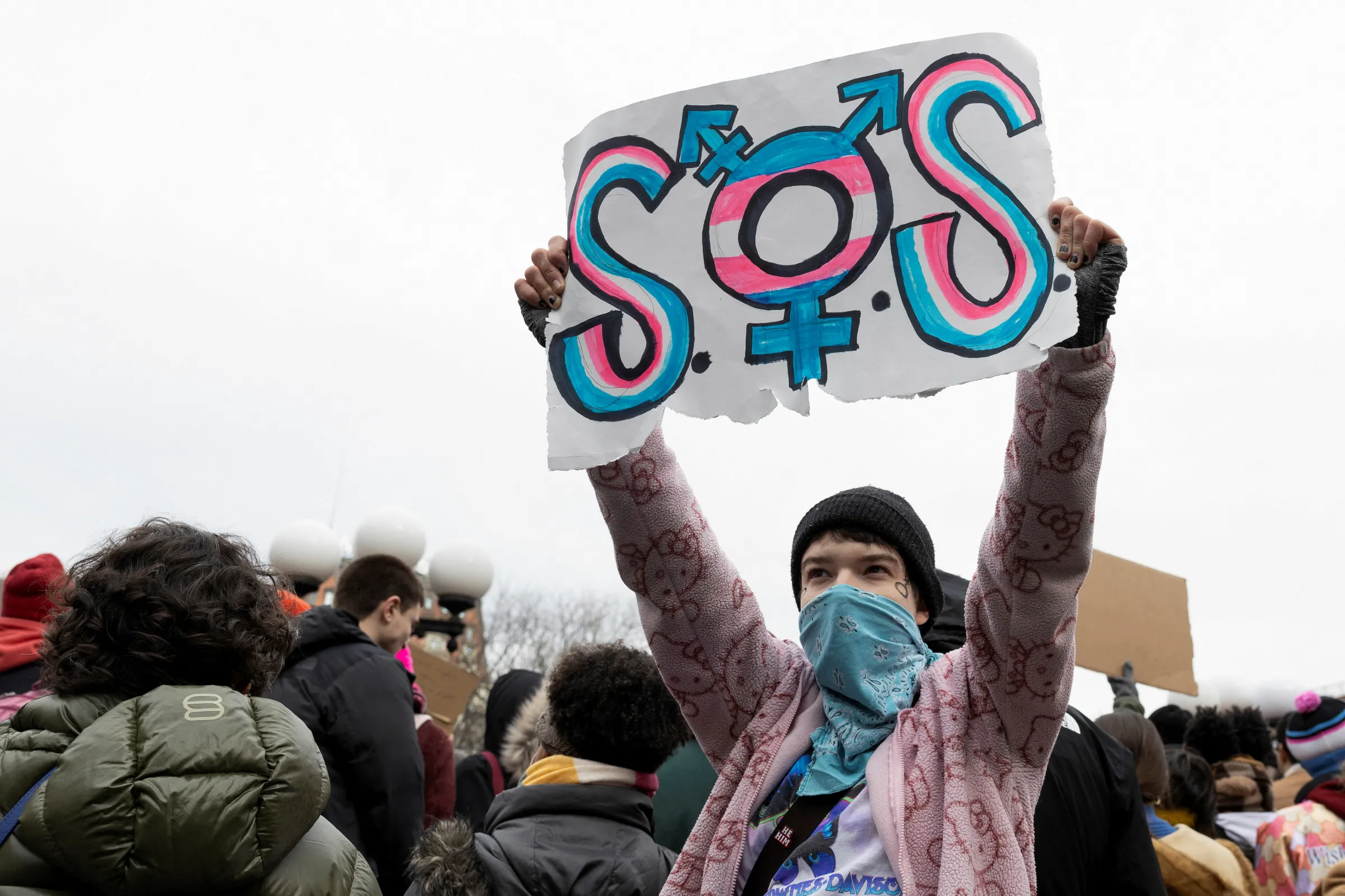 A demonstrator holds a sign at a Rise Up for Trans Youth! event in New York City, U.S., February 8, 2025. REUTERS/Christian Monterrosa